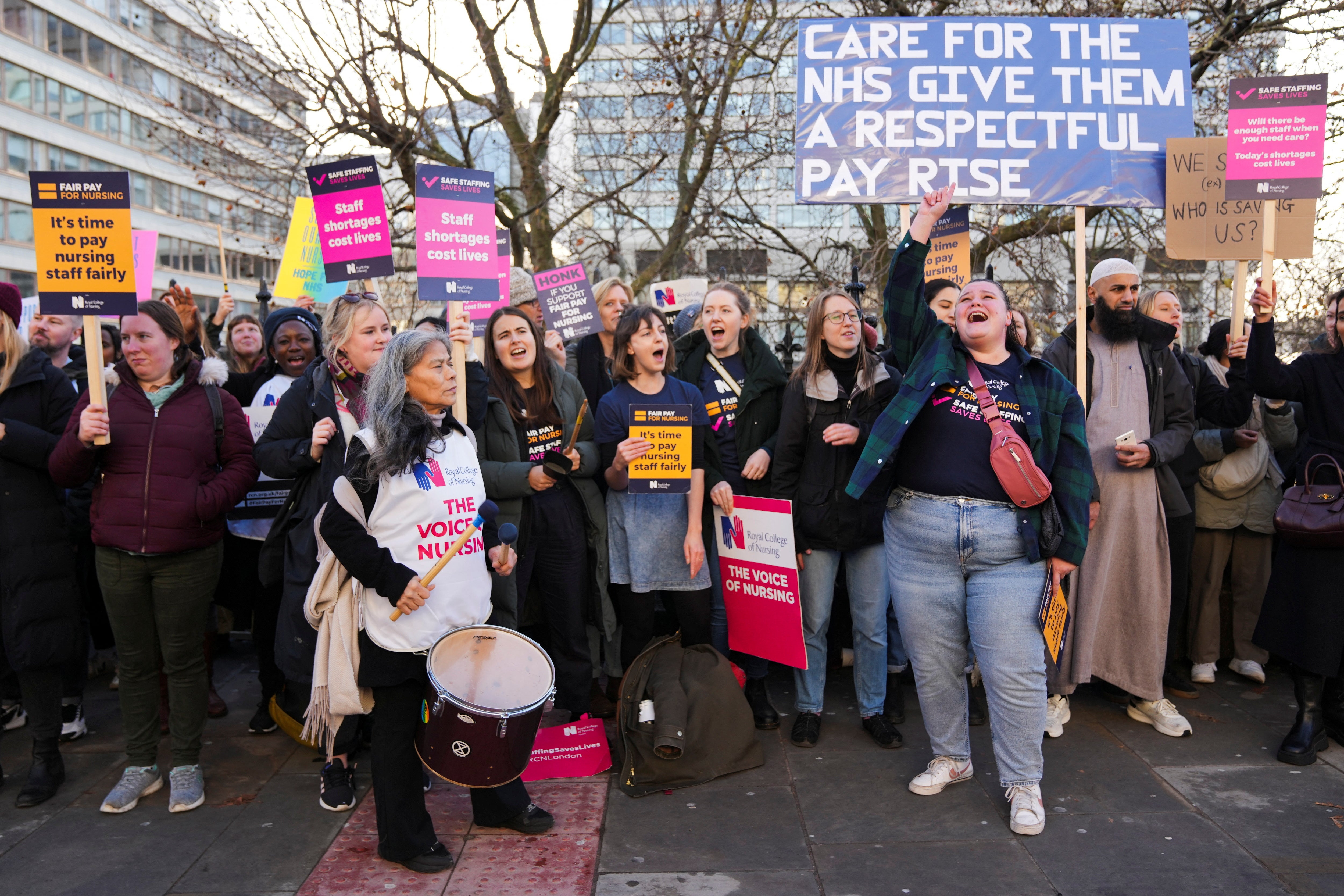 NHS nurses hold placards during a strike, amid a dispute with the government over pay, outside St Thomas' Hospital in London