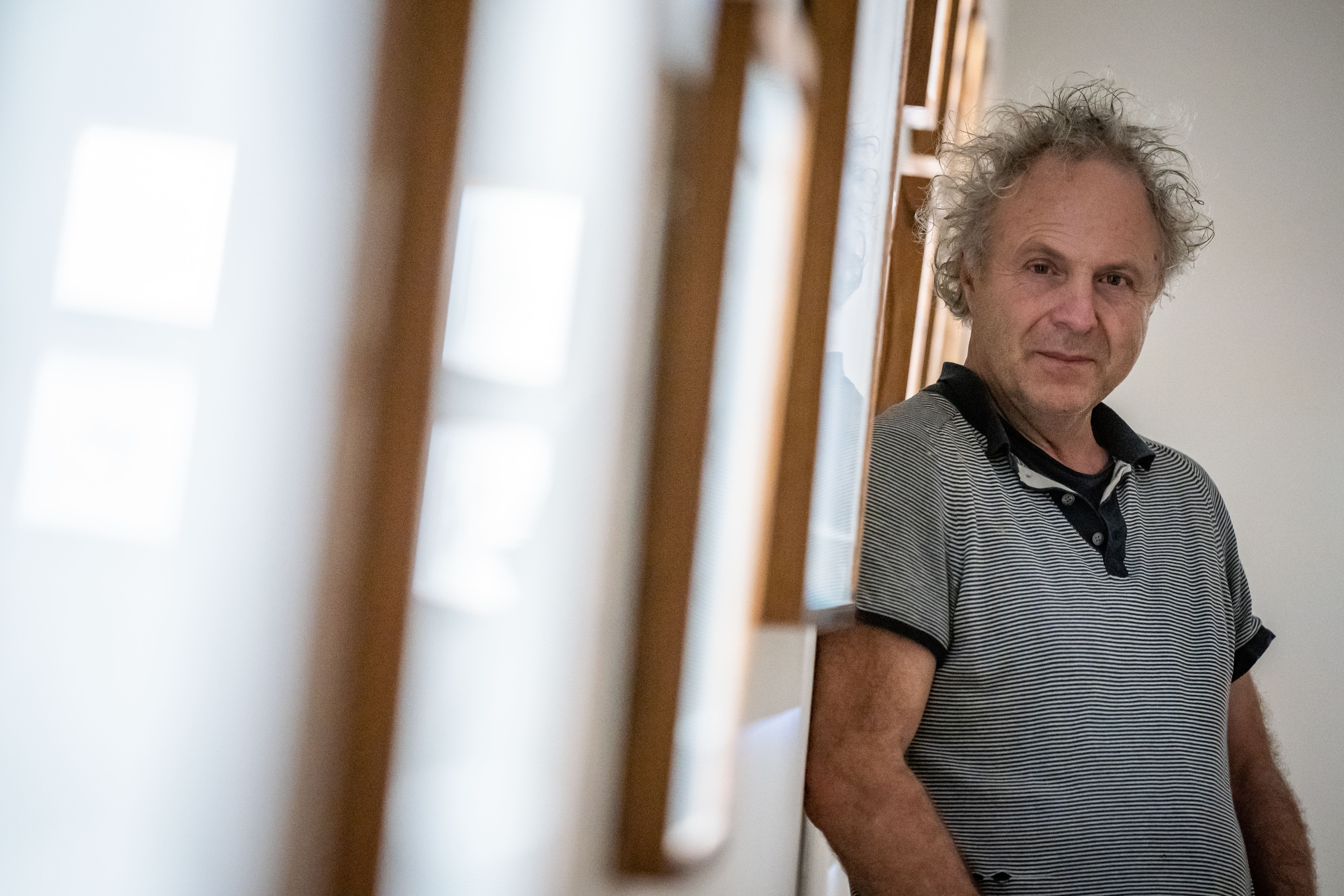 Author and illustrator Charlie Mackesy with his exhibition ‘Look How Far We’ve Come’ at Sotheby’s in London. (Aaron Chown/PA)