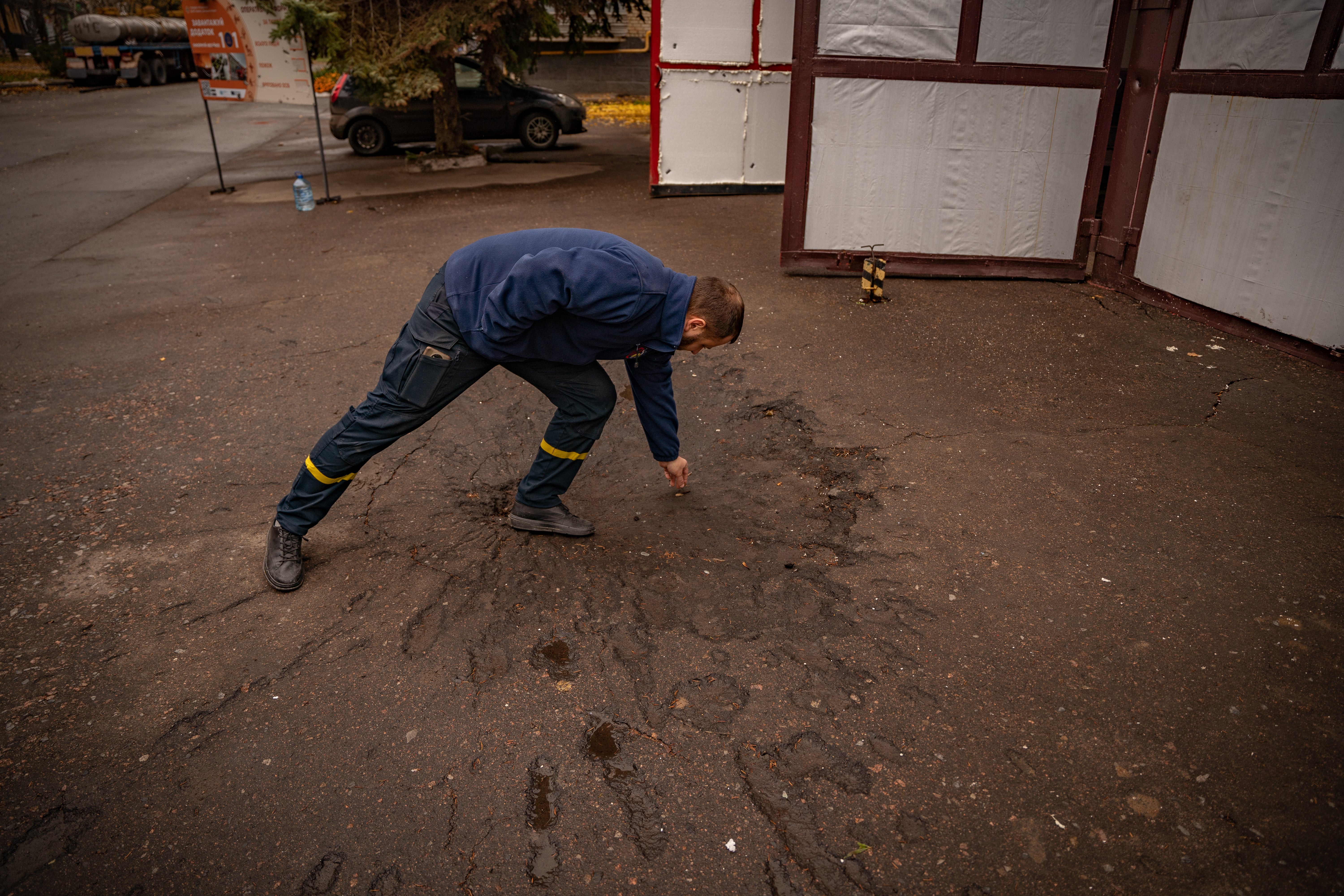 The head of Bakhmut’s fire department stands beside where a rocket hit their station