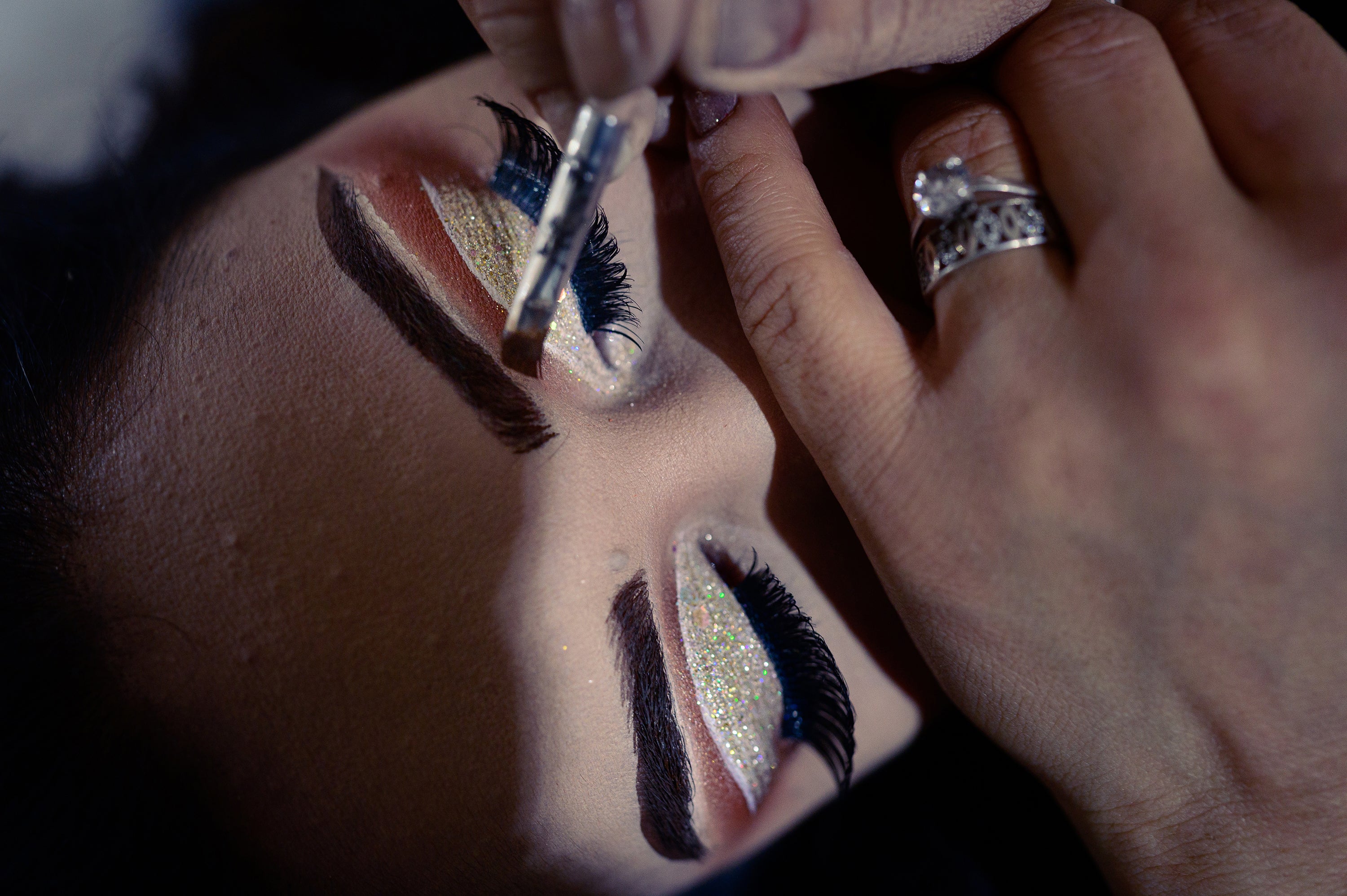 A woman has her makeup done at a beauty salon in Shahr-e Naw before a wedding where she will be a guest