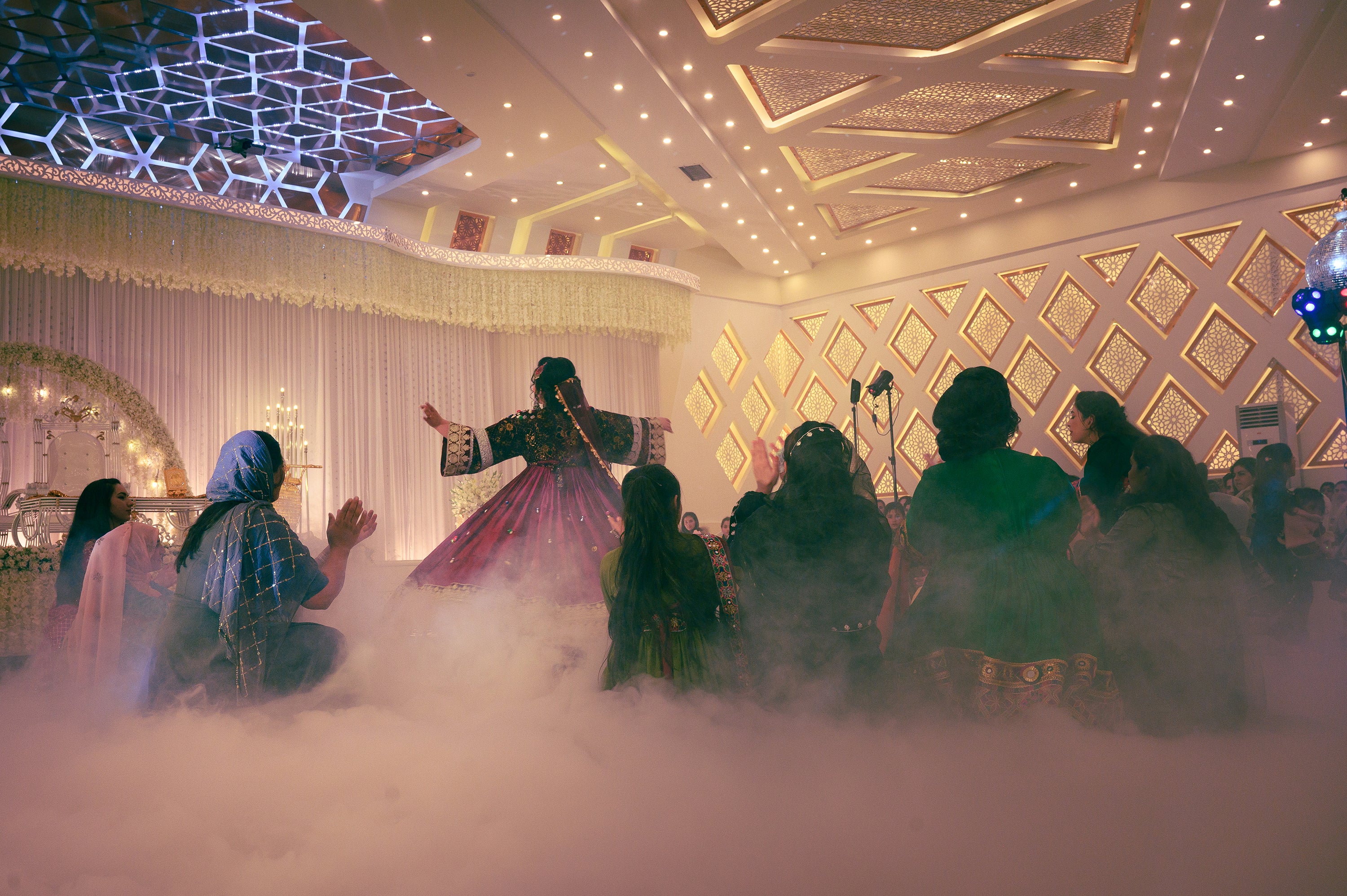 Sabrina dances in front of clapping family members at her wedding celebration