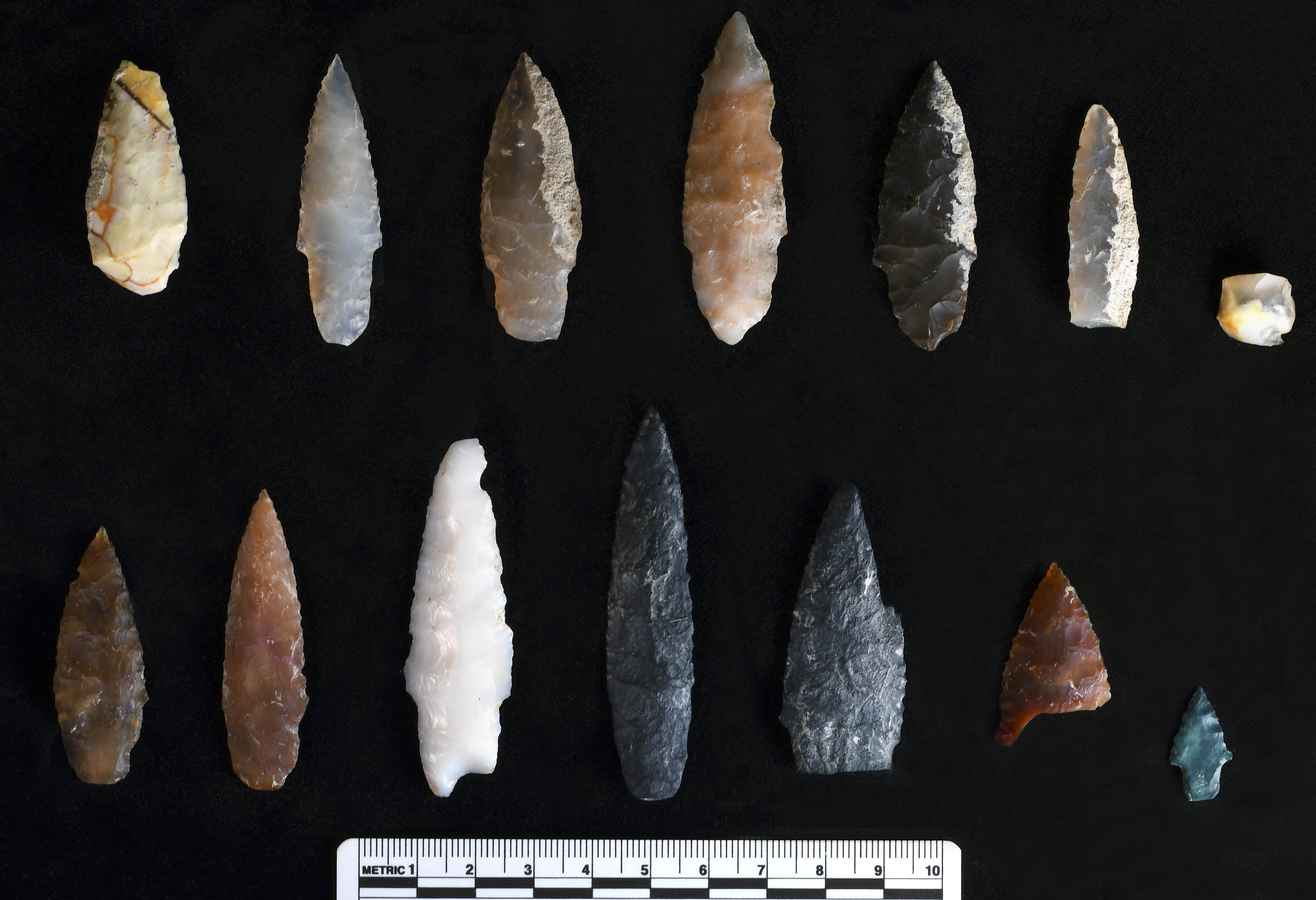 Stone projectile points discovered buried inside and outside of pit features