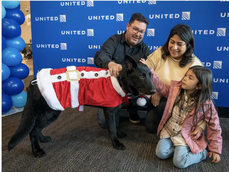 The puppy with his new family at the airport