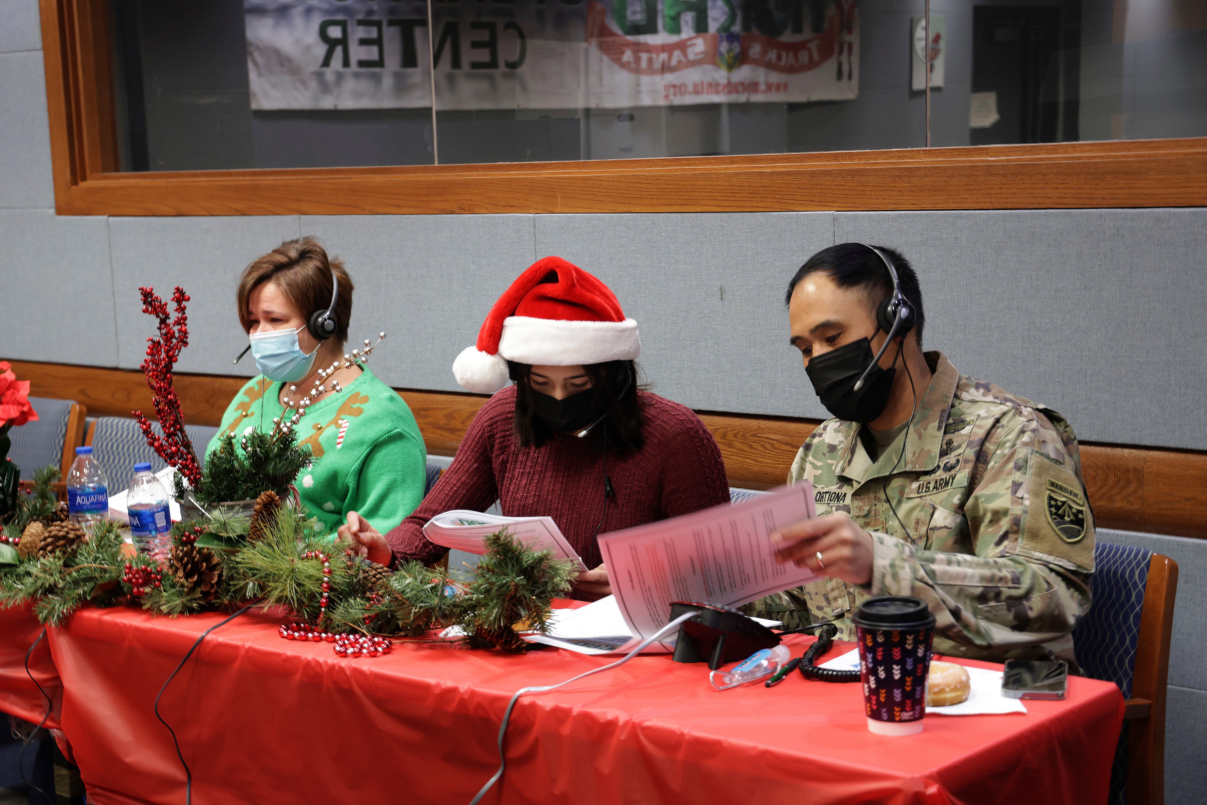 Festive volunteers answer phones and emails from children around the globe at last year’s NORAD Tracks Santa event at Peterson Air Force Base in Colorado Springs