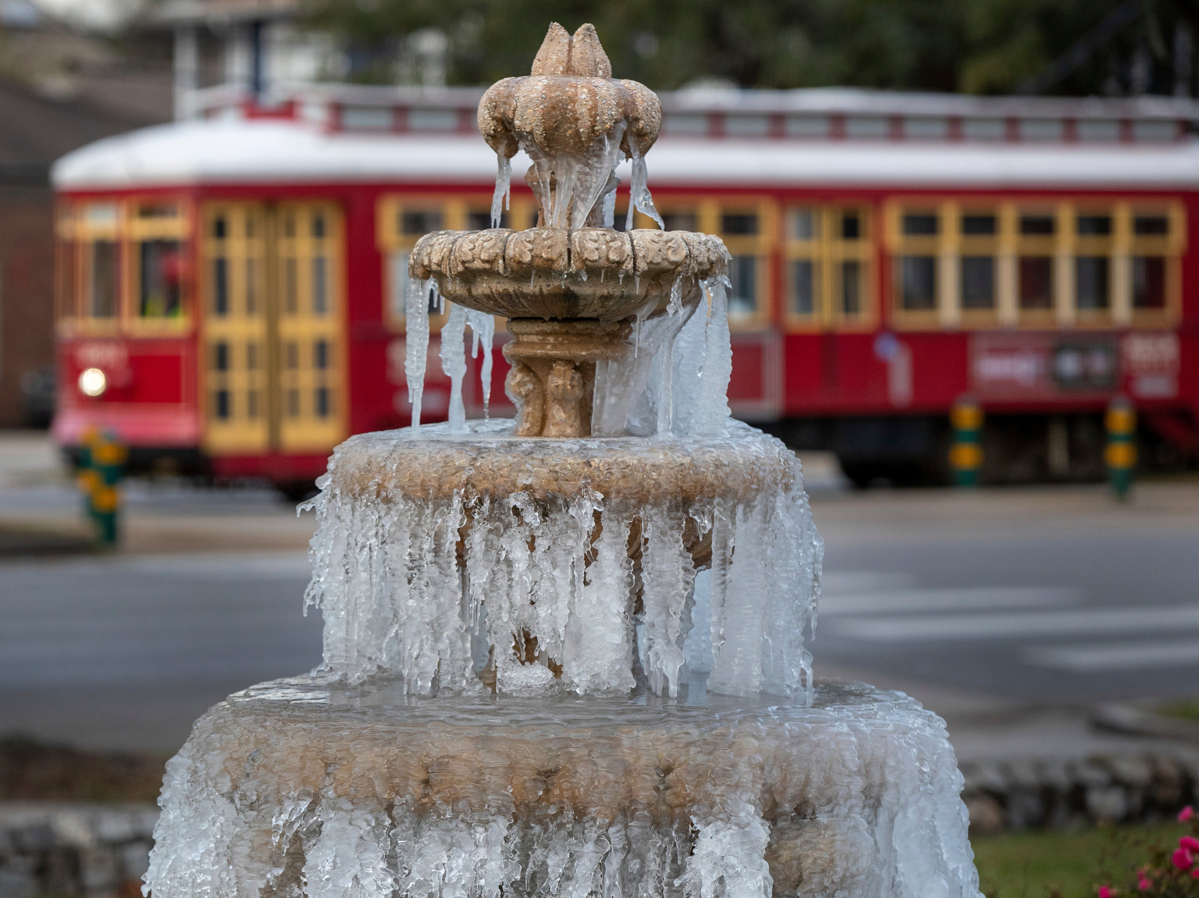 The fountain is frozen as temperatures hovered in the mid 20's at Jacob Schoen & Son Funeral Home in New Orleans, Saturday, Dec. 24, 2022