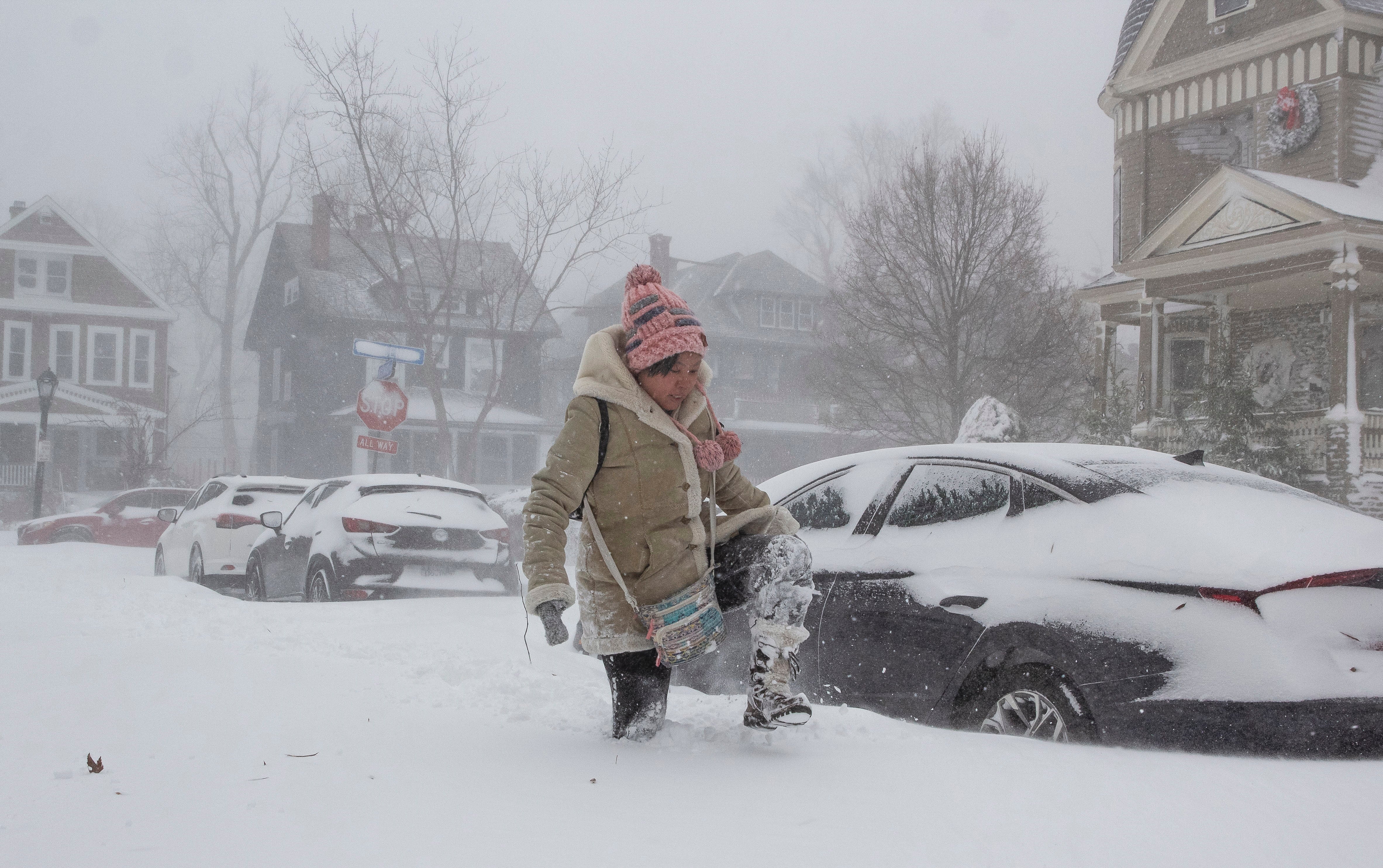 Jessica Chan of Buffalo, New York, navigates deep snow as a large winter storm, which is affecting large portions of the United States, continues to hit Buffalo, New York