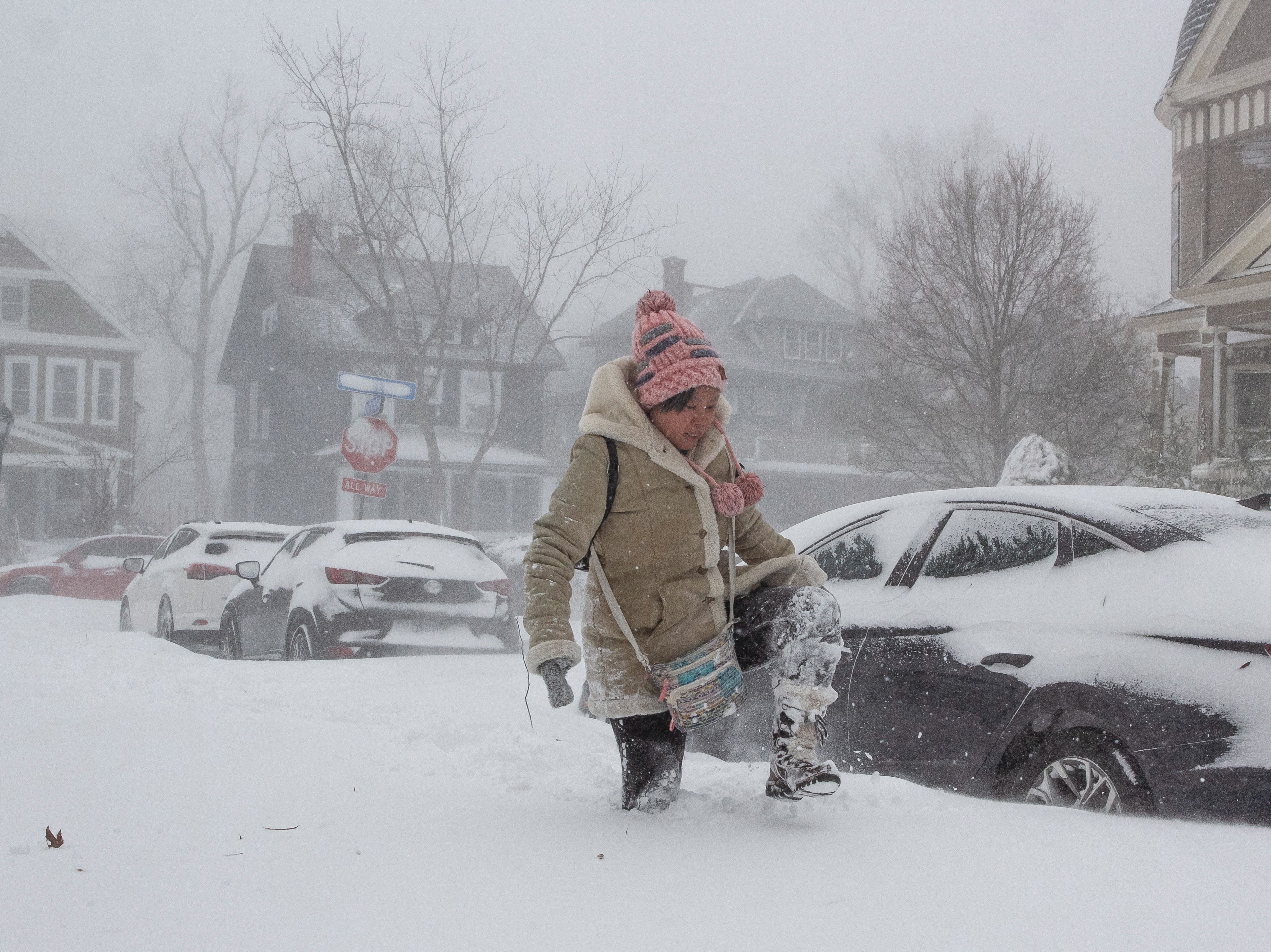 Jessica Chan of Buffalo, New York, navigates deep snow as a large winter storm