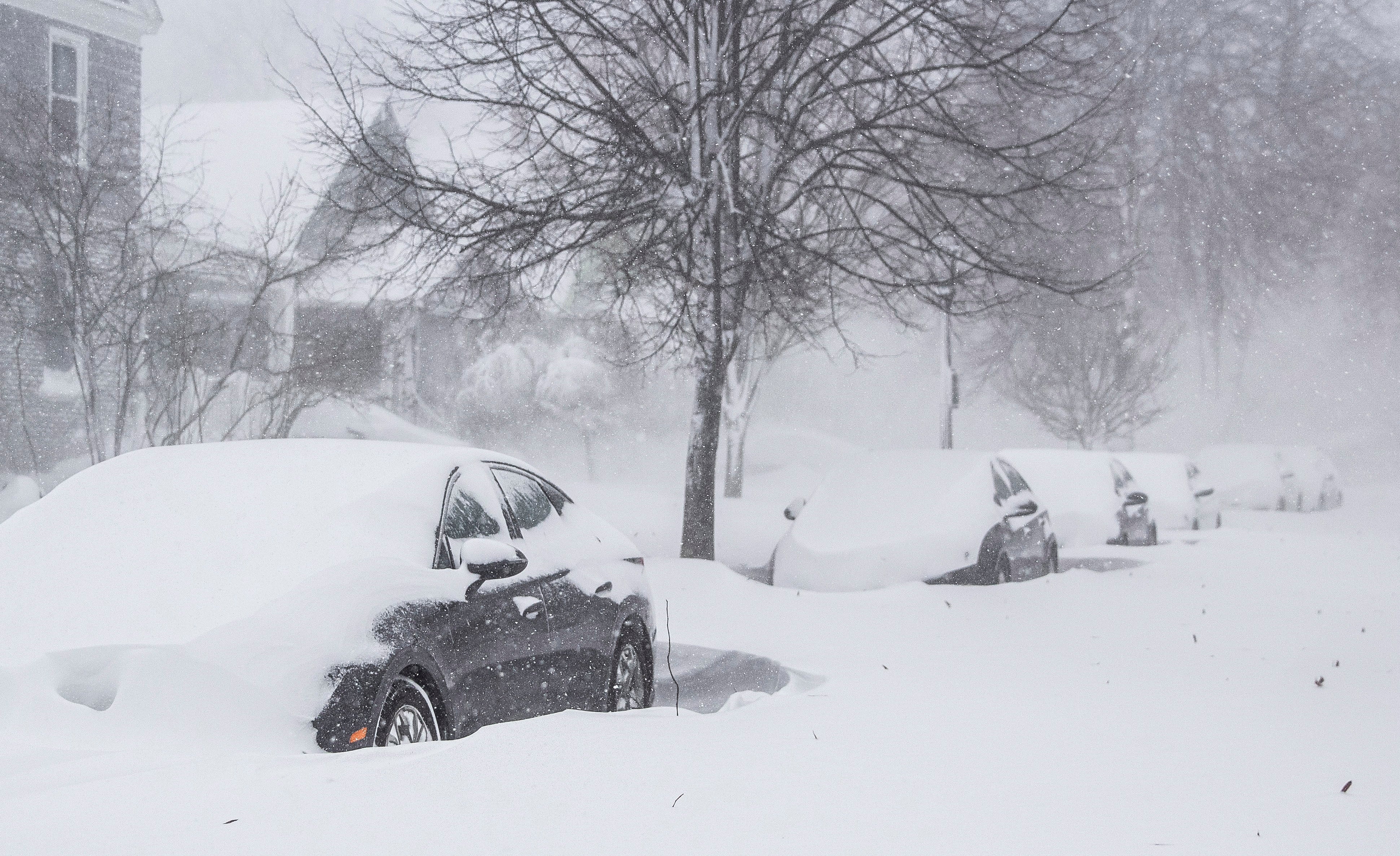 Cars covered in snow as a large winter storm, which is affecting large portions of the United States, continues to hit Buffalo