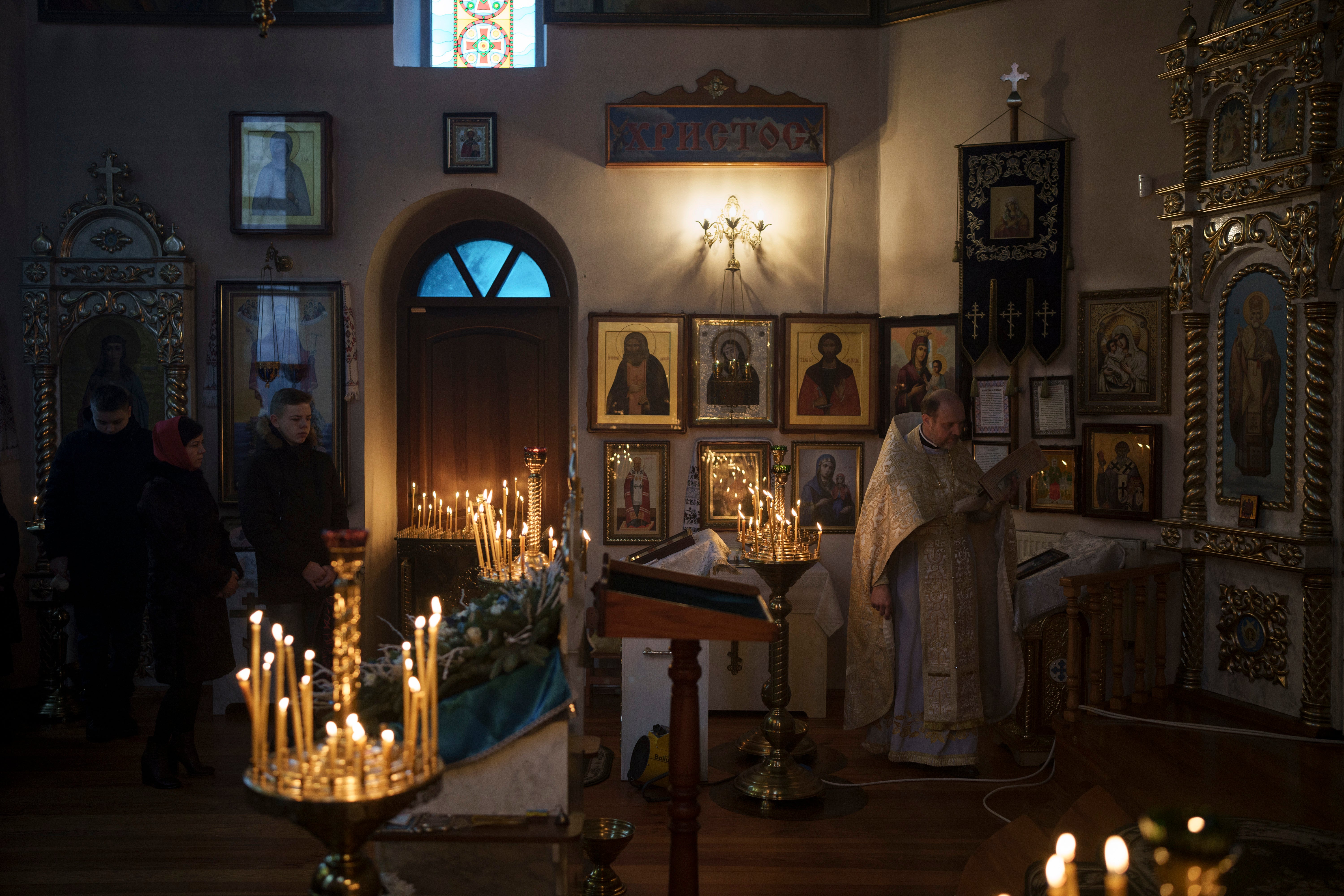 Ukrainians attend a Christmas mass at an Orthodox Church in Bobrytsia, near Kyiv, on Sunday