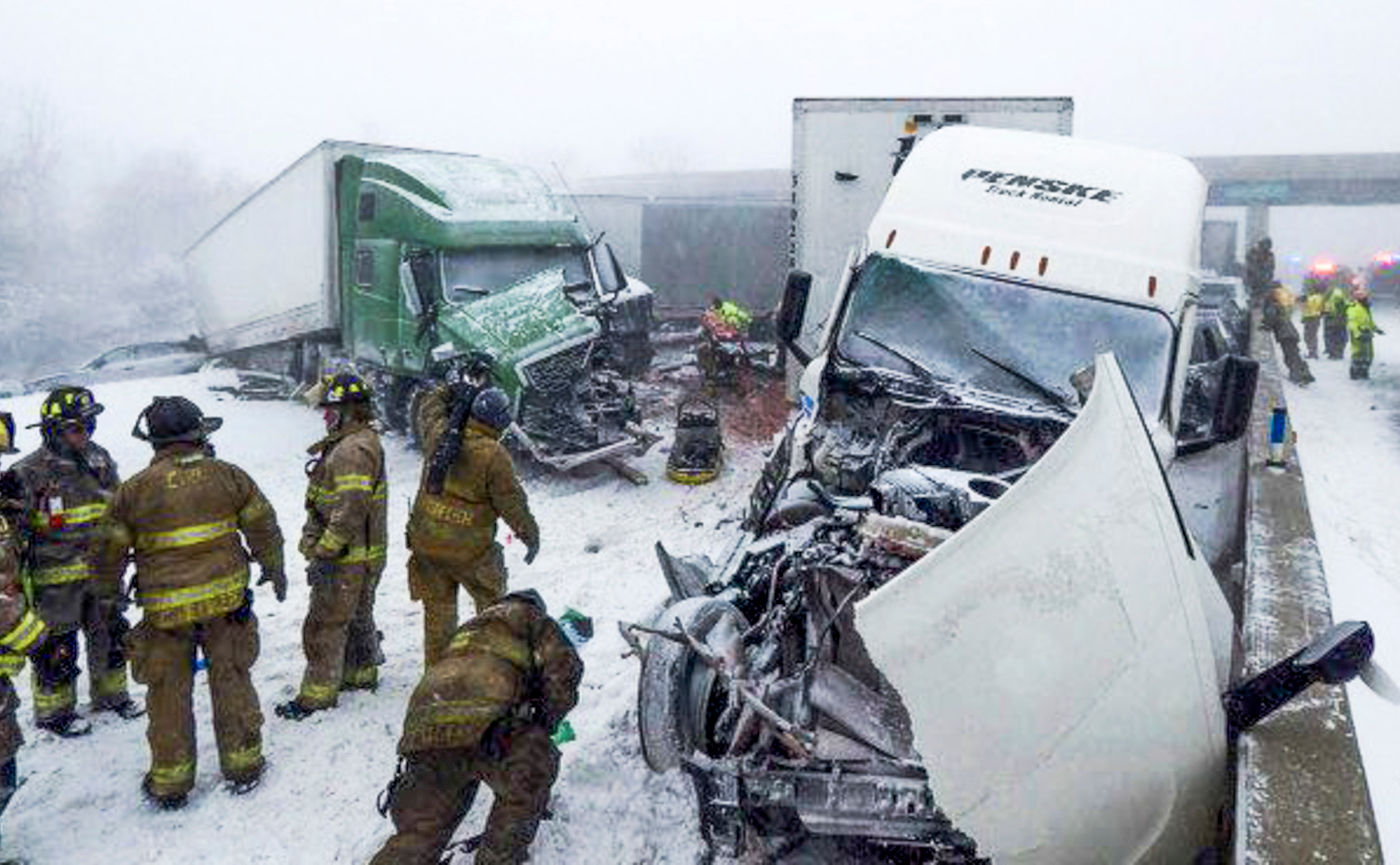 Rescuers at the scene of a multi-vehicle crash in which four people died and many were injured on the Ohio Turnpike in Erie County, Ohio