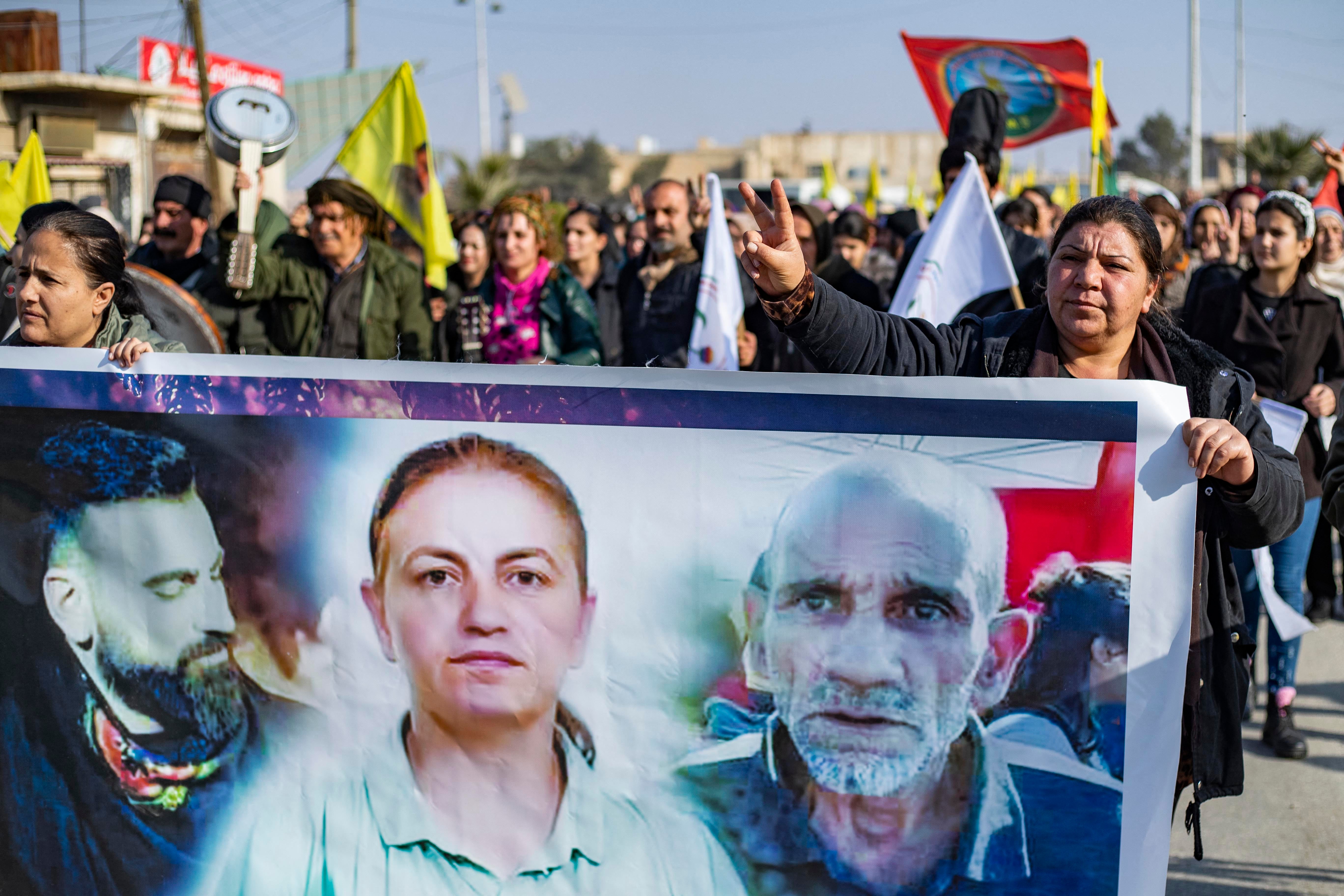 Kurds hold a banner featuring victims of the Paris shooting at a protest in Syria’s northeastern city of Hasakeh on Sunday