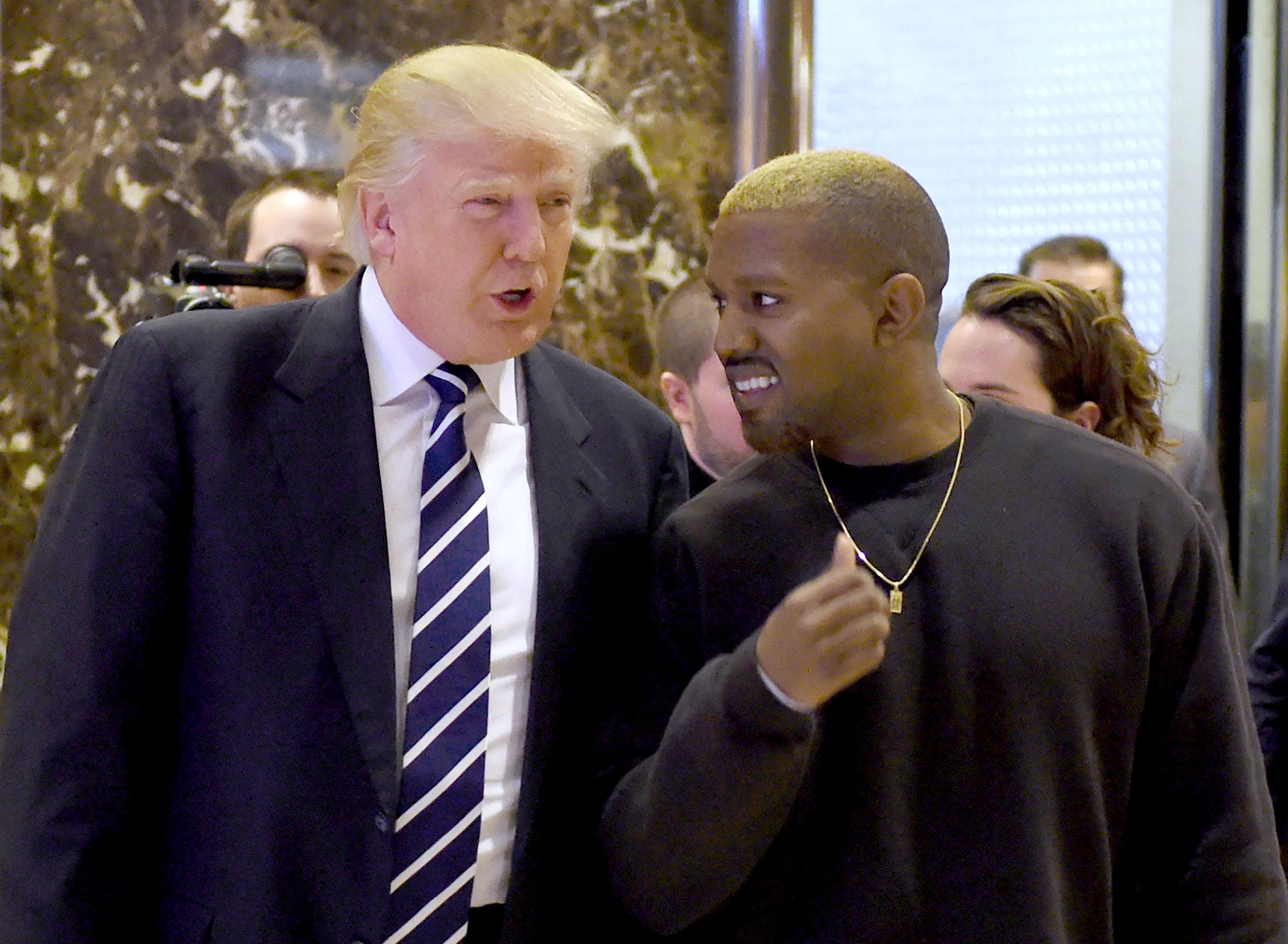 Former president Donald Trump and rapper Kanye West are pictured in 2016