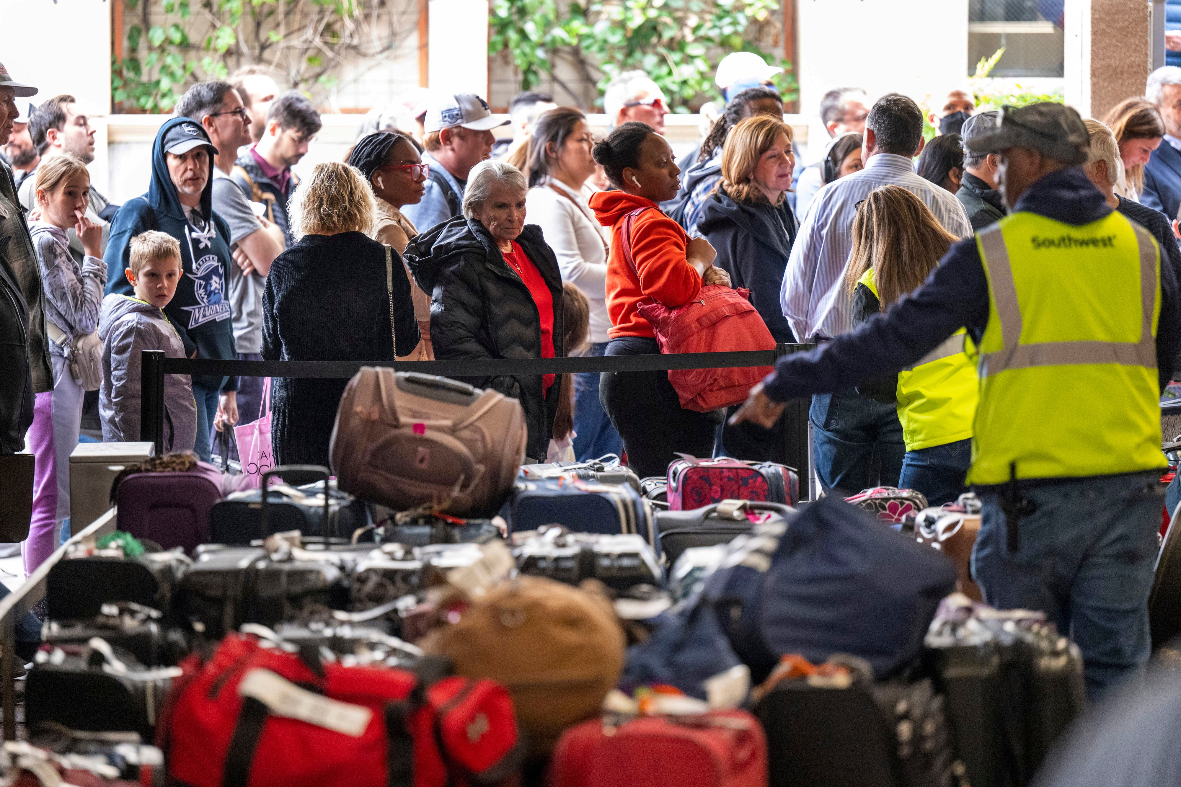 Passengers wait to retrieve their luggage at Hollywood Burbank Airport, Tuesday, Dec 27, 2022, in Burbank, California.