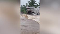 House collapses in raging flood water as Philippines hit by torrential rain