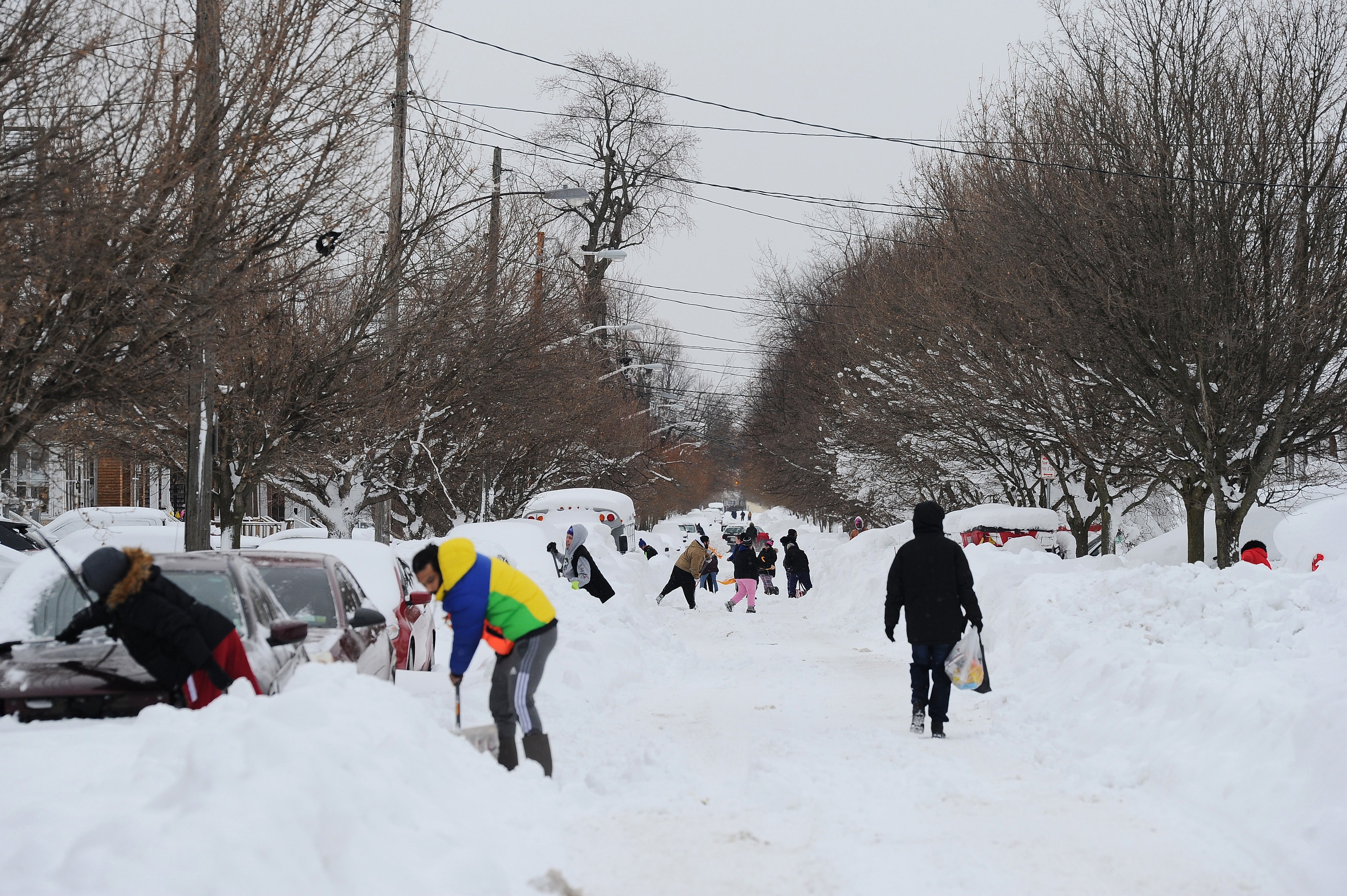 Buffalo residents work to clear snow from the streets on 27 December