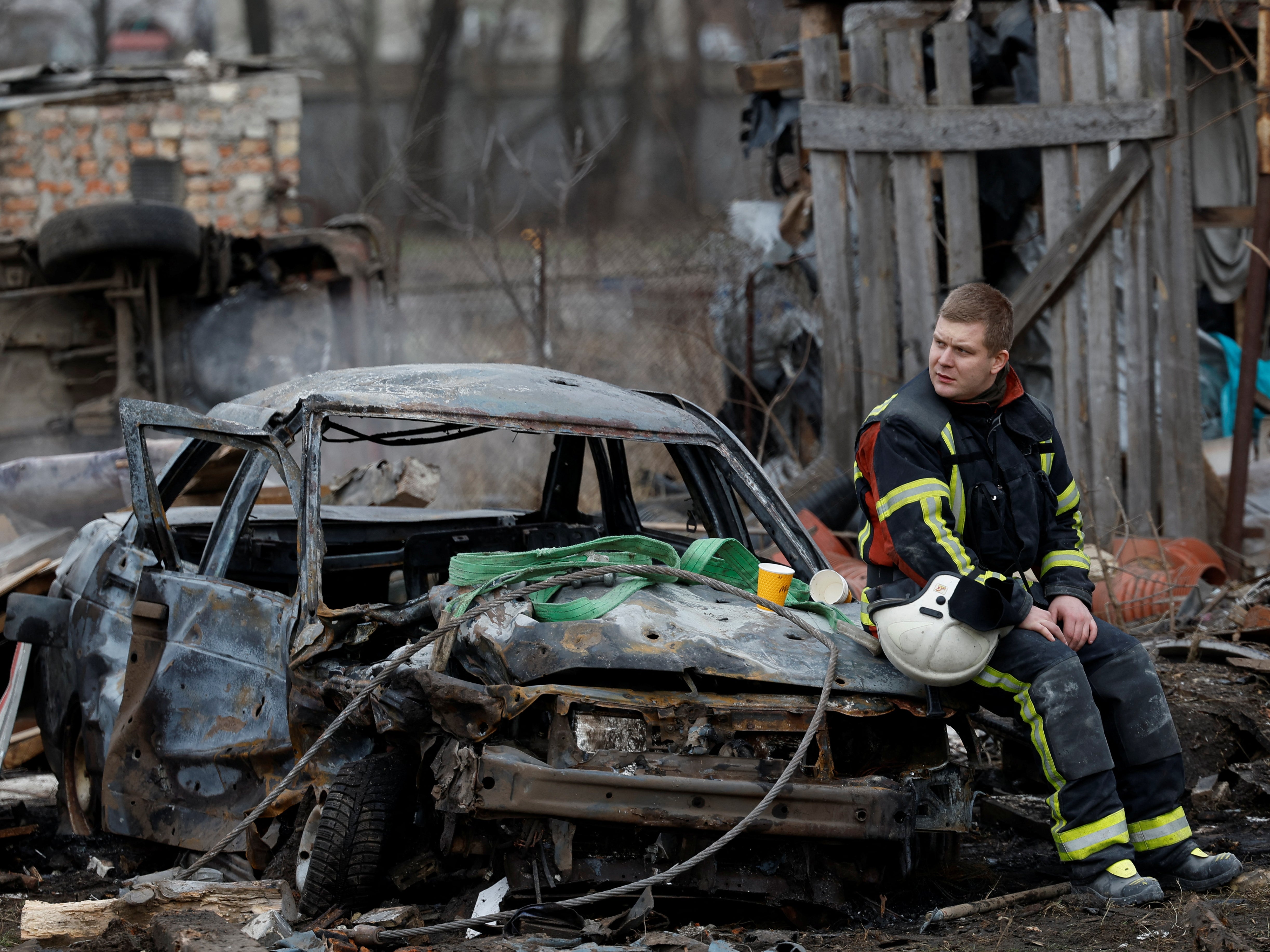 A rescuer at a site damaged in a missile strike in Kyiv