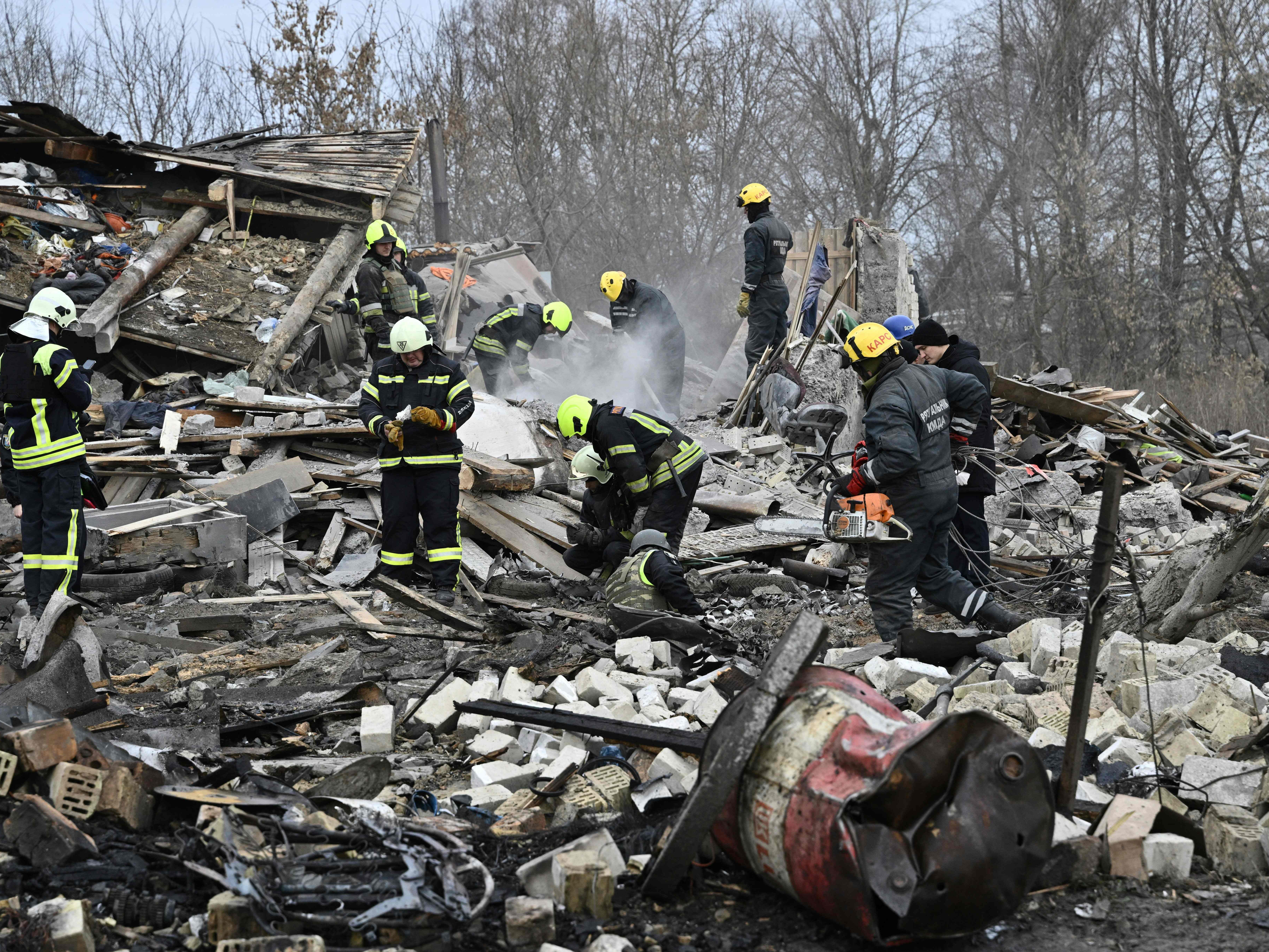 Rescuers clear the debris of homes in Kyiv