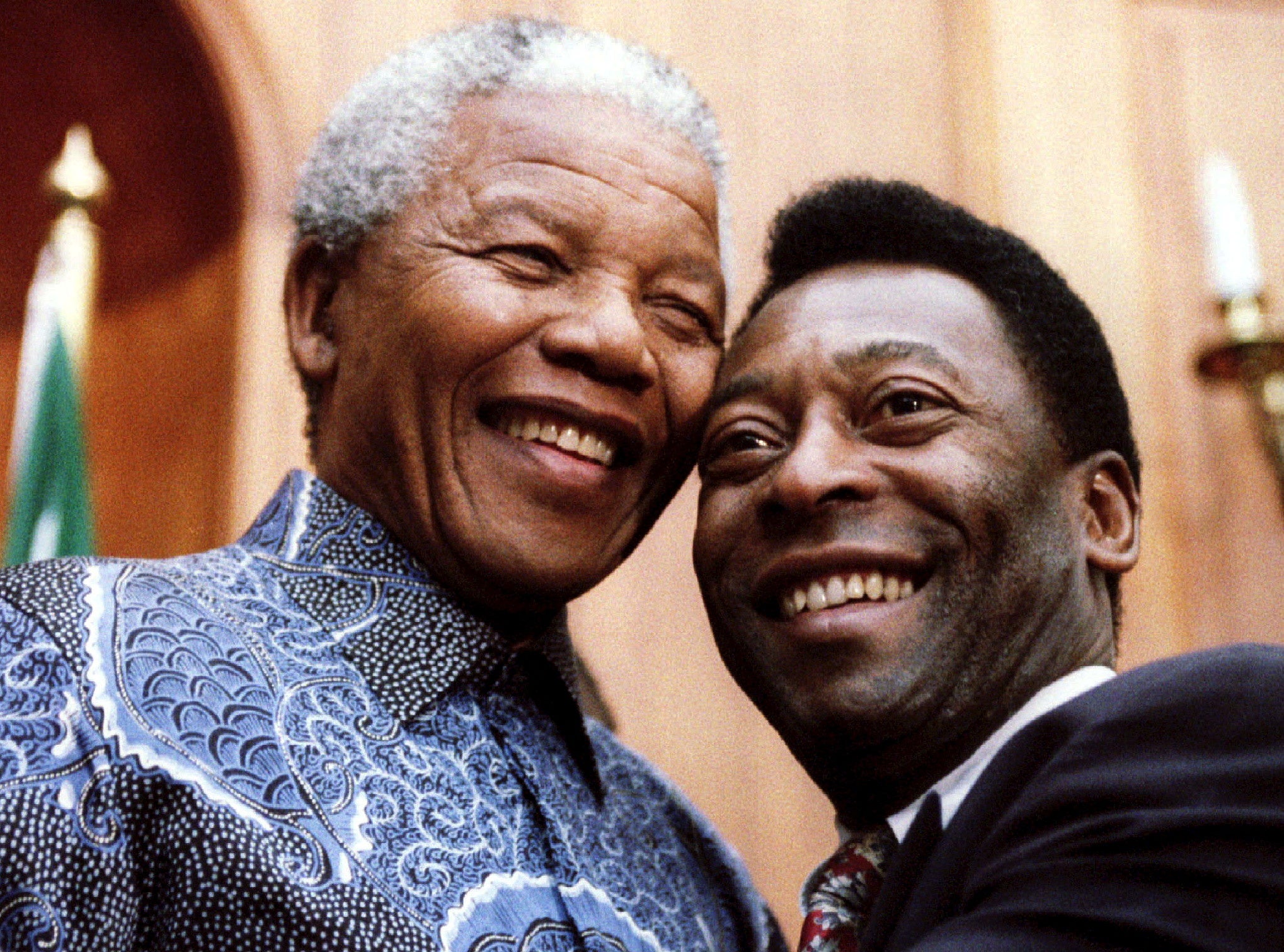 President Nelson Mandela and Pele smile for photographers at Union Buildings in Pretoria, South Africa, March 24, 1995.