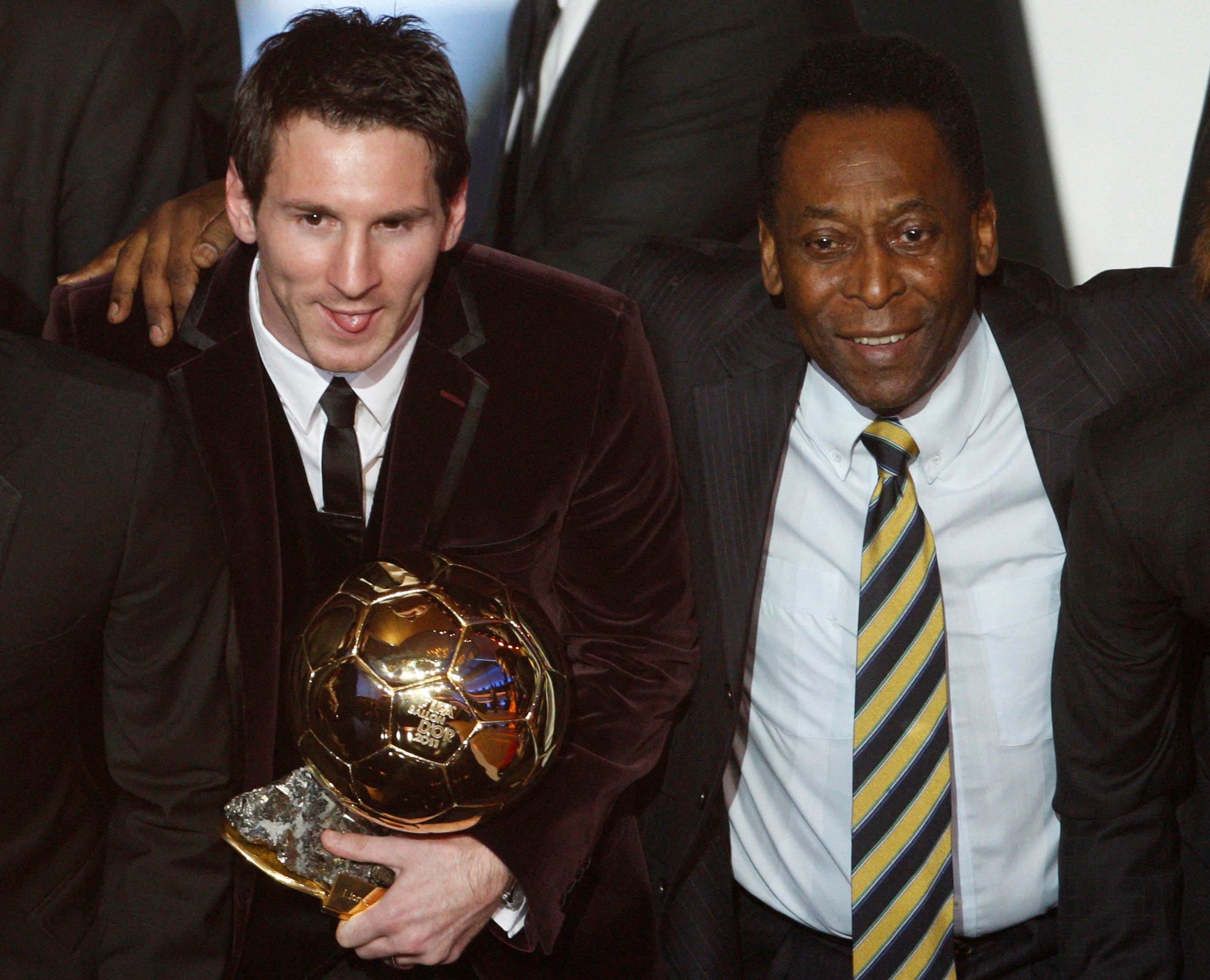 Lionel Messi holds the Ballon d’Or 2011 trophy next to Pele during the awards ceremony in Zurich