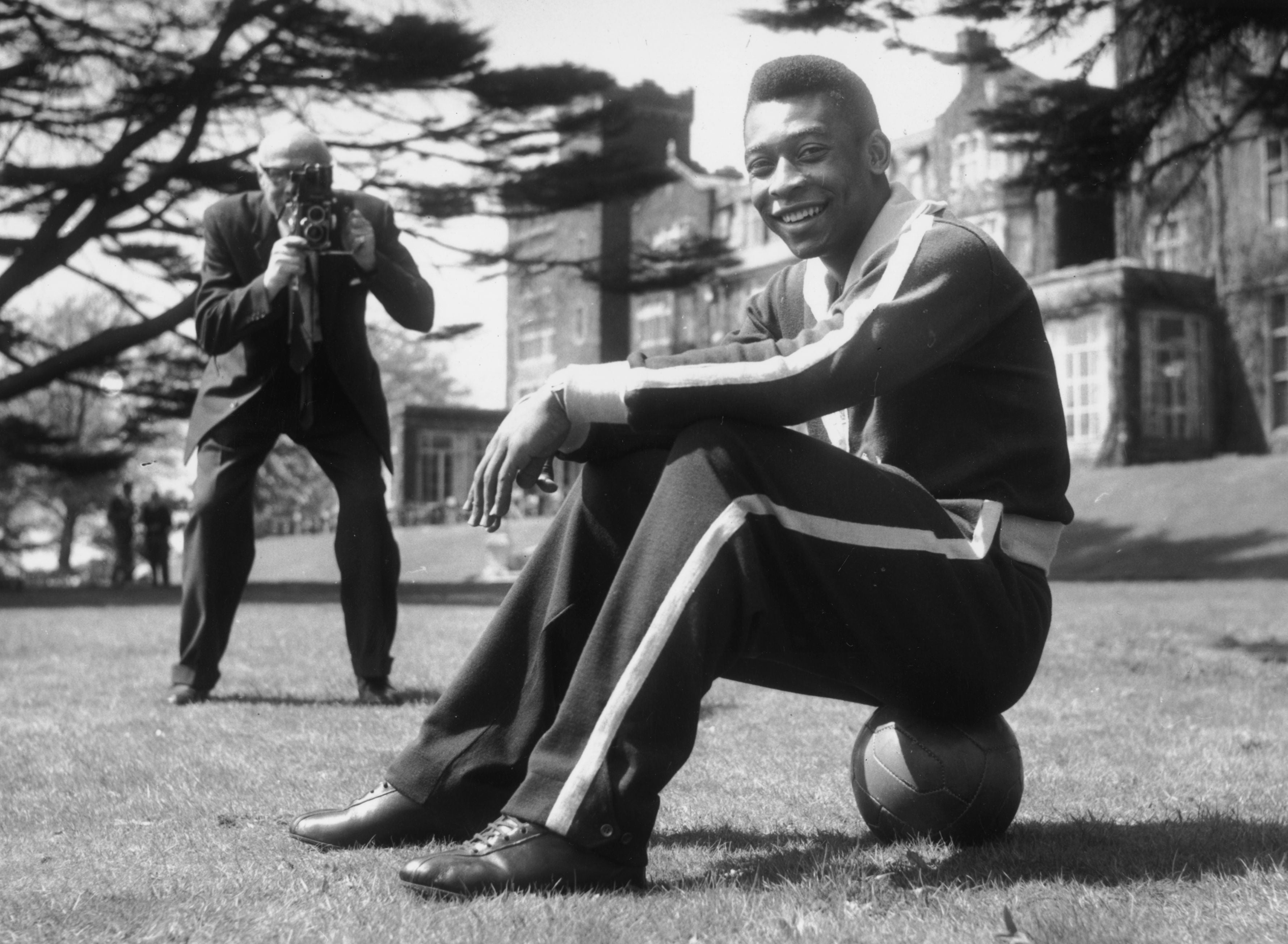 7th May 1963: Star of the Brazilian football team, Pele sits on the ball during a break in training at Selsdon Park Hotel where they were staying. The Brazilians were to play England at Wembley