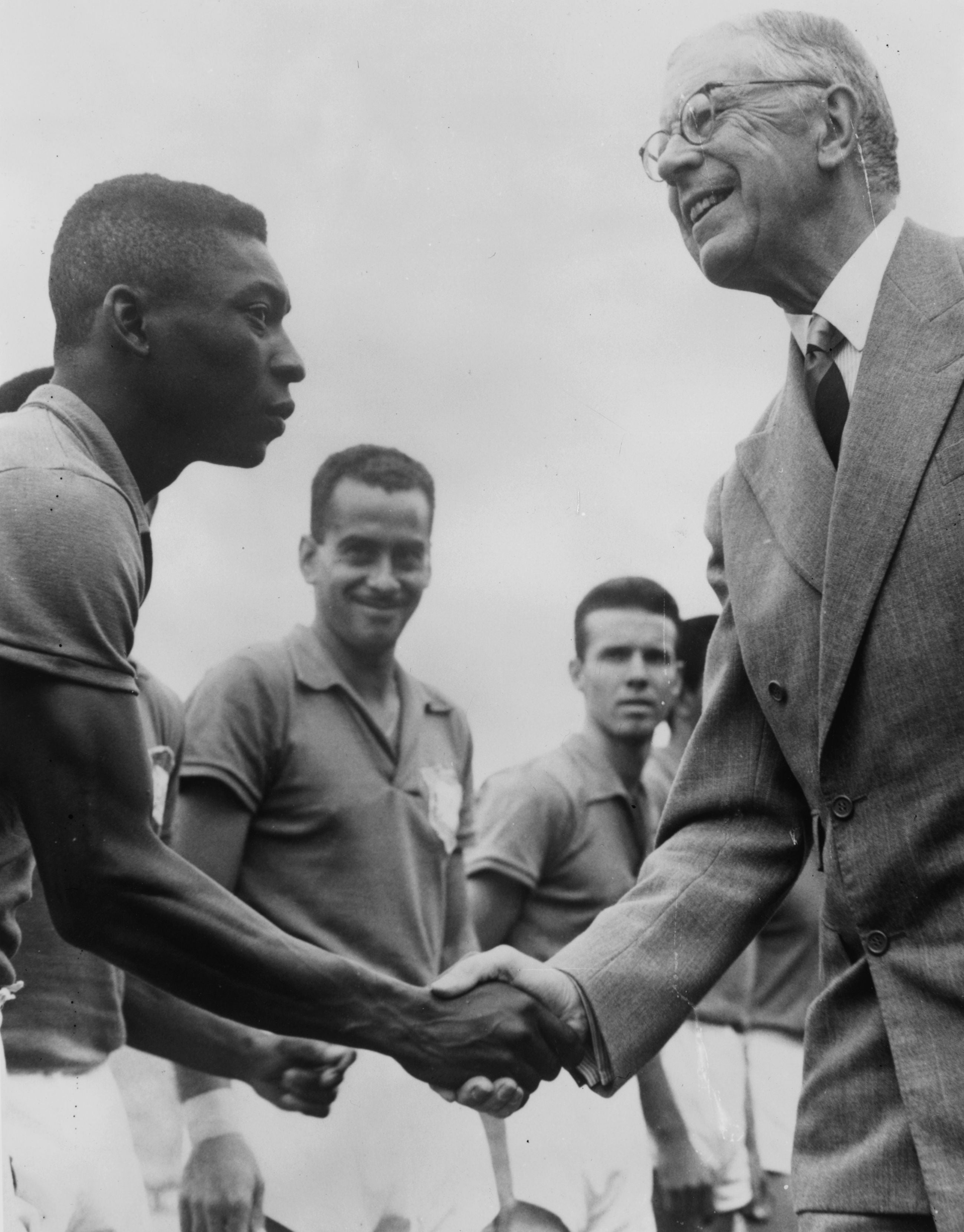 30th June 1958: Gustav VI Adolf, king of Sweden, (right) shakes hand with Pele before the final of the World Cup between Brazil and Sweden.