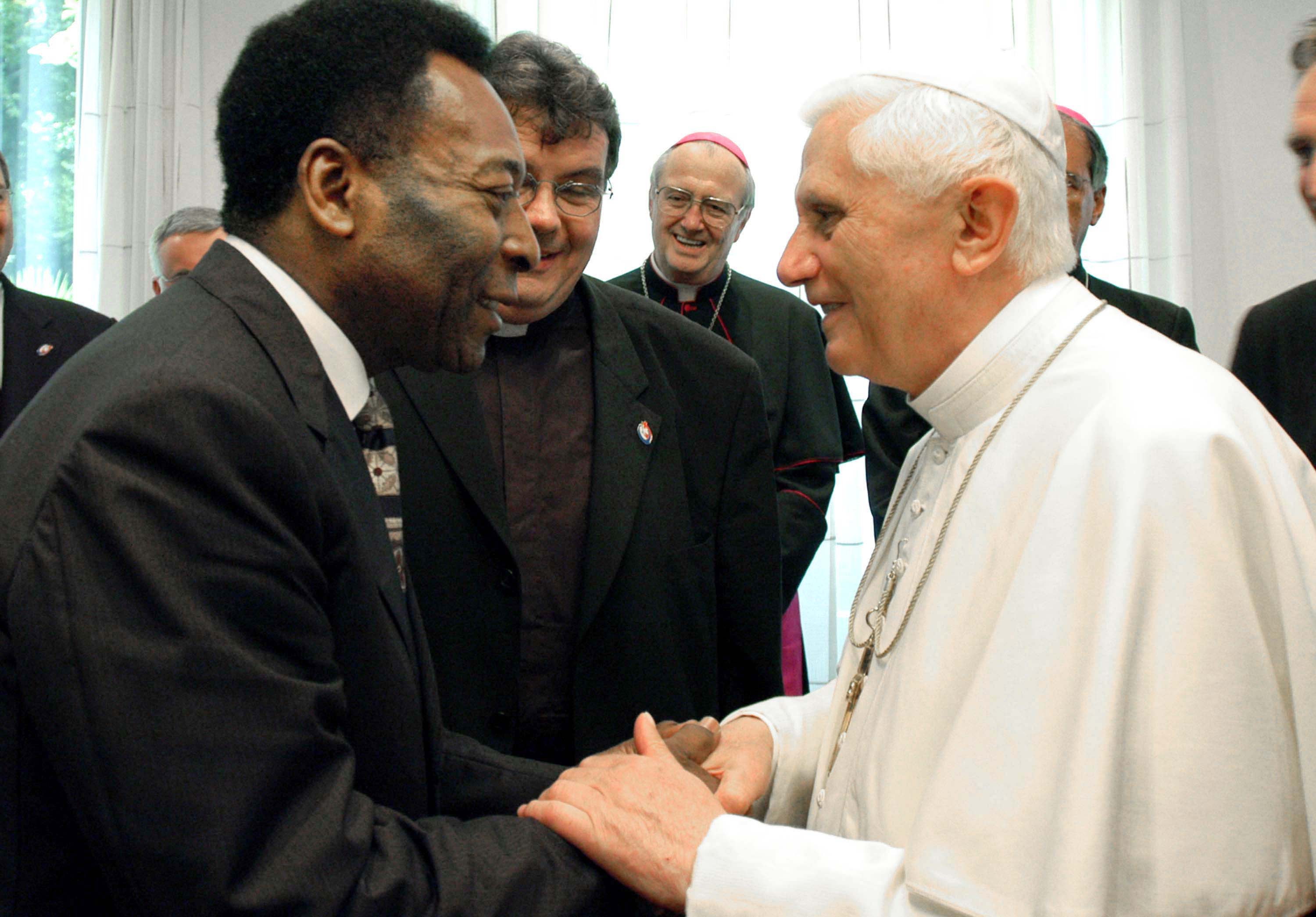 Pope Benedict XVI shakes hands with Pele during their meeting August 20, 2005 in Cologne, Germany.