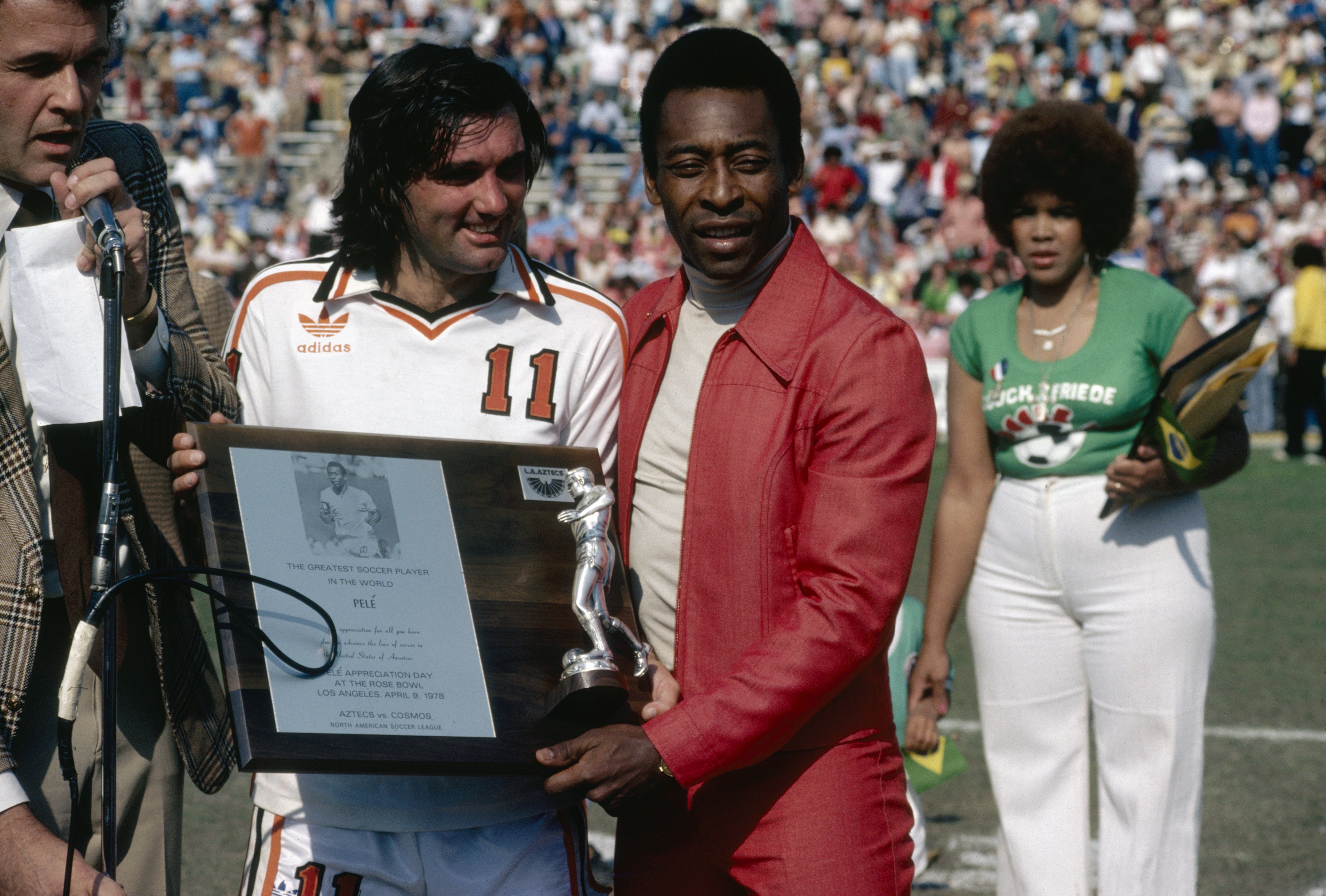 George Best presents Pele with a plaque commemorating the Brazilian as the best soccer player in the world during Pele Appreciation Day at Rose Bowl stadium in Pasedena, California, 9th April 1978. A friendly match was played between the Aztecs and Cosmos to mark the occasion.