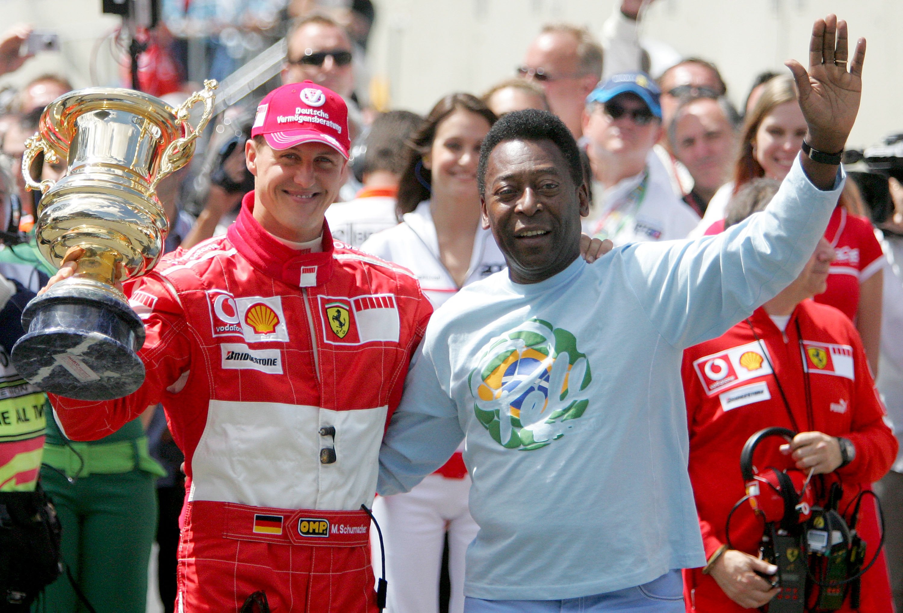 Michael Schumacher of Germany and Ferrari receives a trophy for his achievements in F1 racing from Pele during the Brazilian Formula One Grand Prix at the Autodromo Interlagos on October 22, 2006 in Sao Paulo, Brazil.