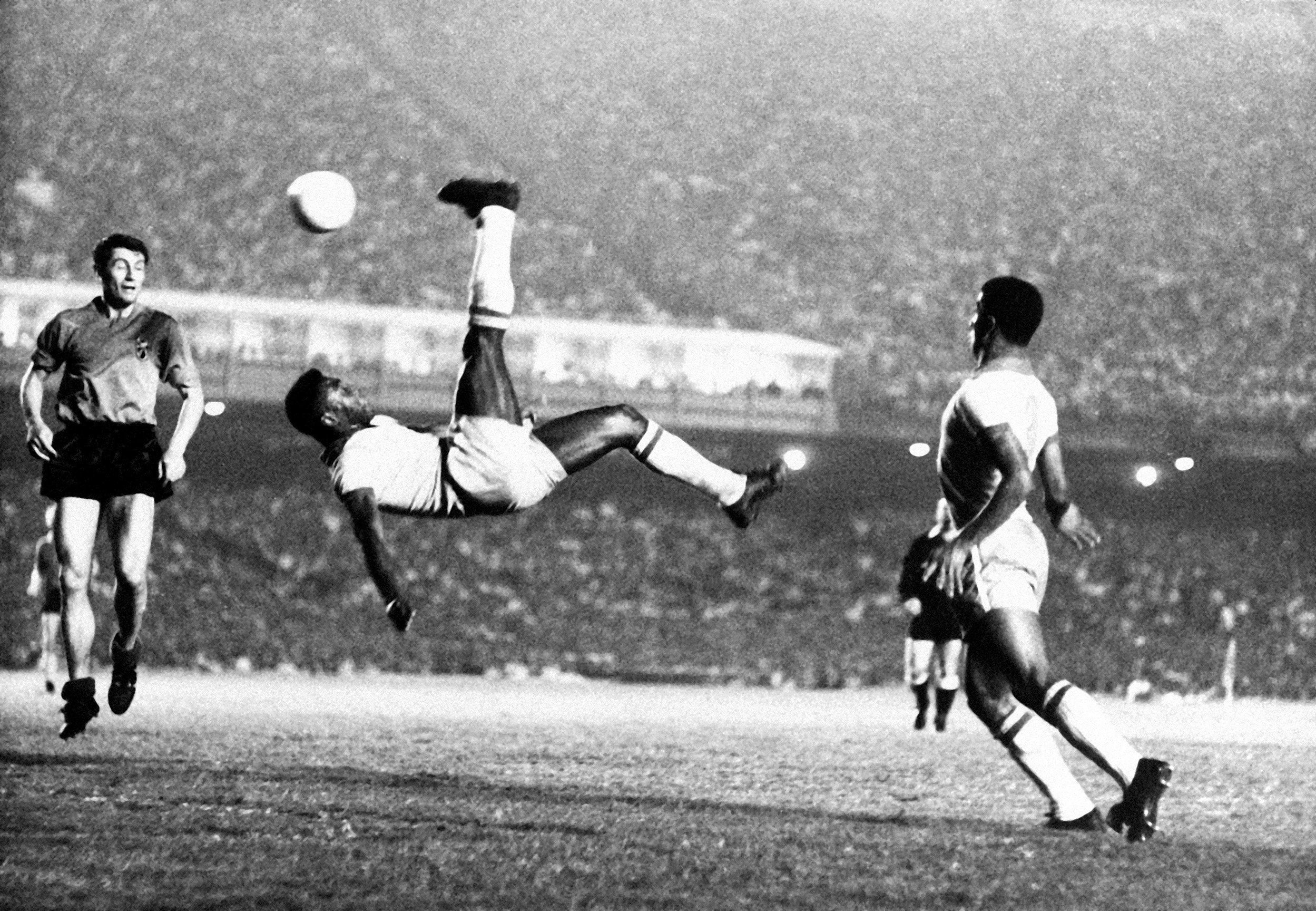 Pele bicycle kicks a ball during a game at unknown location, September 1968.