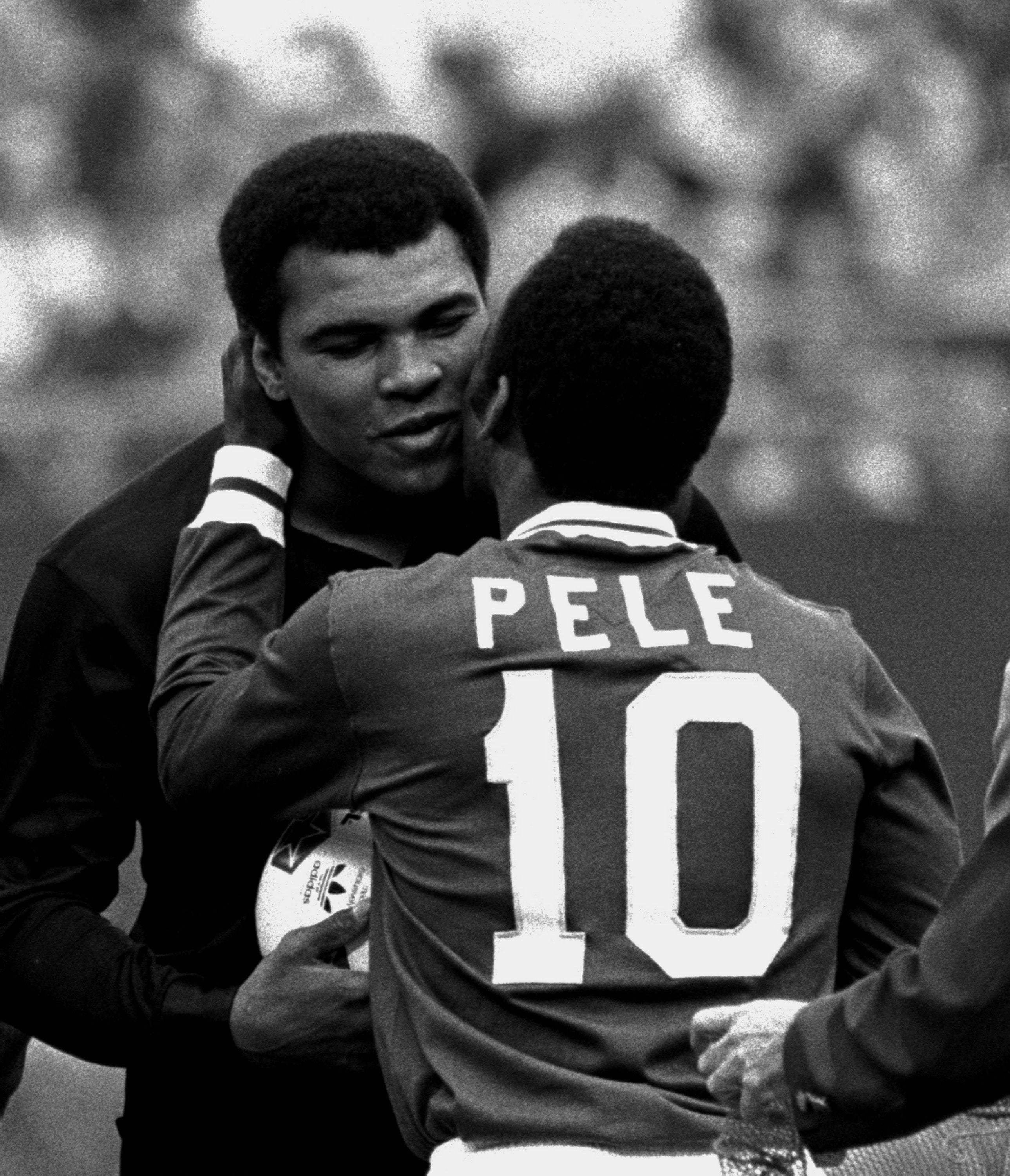 Pele embraces boxer Muhammad Ali during a ceremony honoring the Brazilian star of the New York Cosmos at Giants Stadium, East Rutherford, N.J., 1 October, 1977.