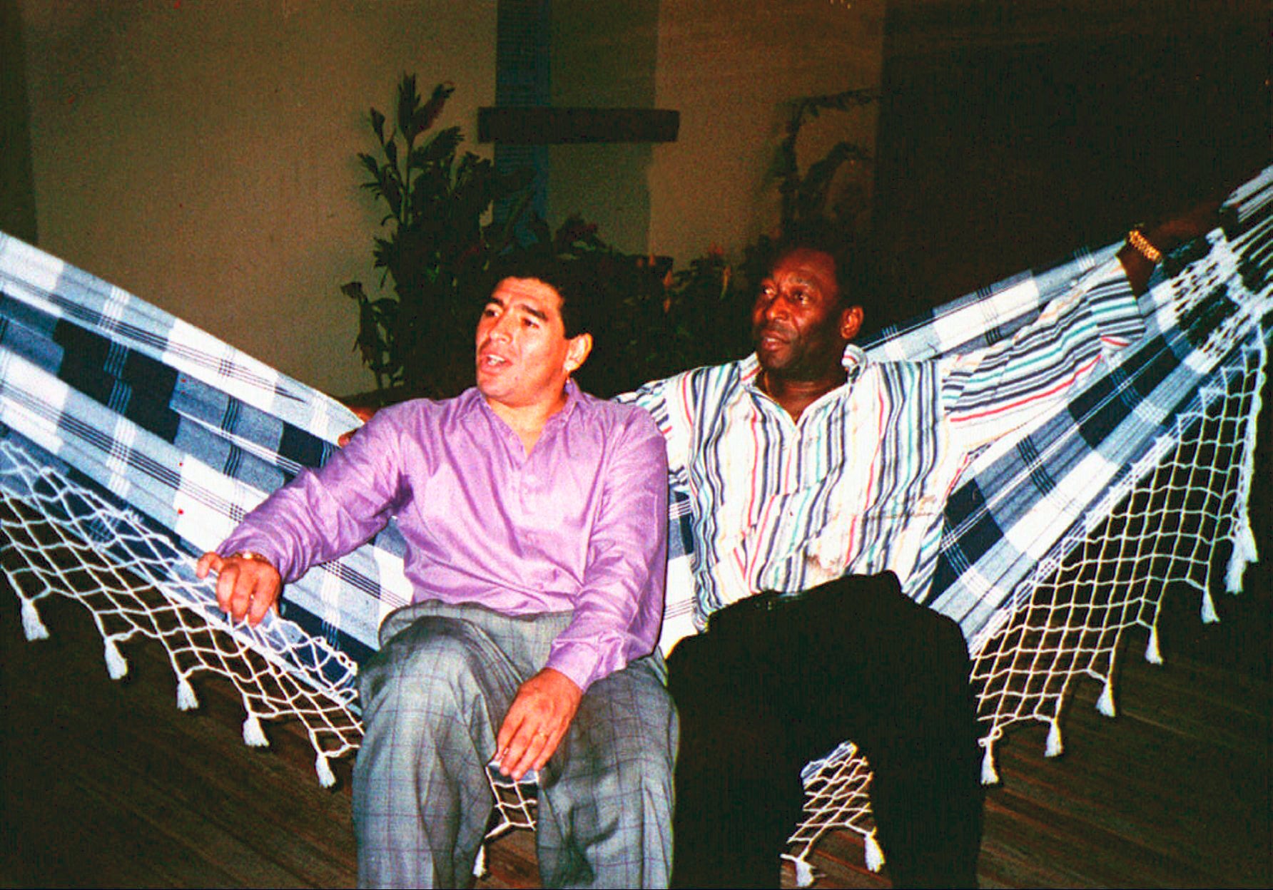 Diego Maradona, left, rests in a hammock with Pele during a meeting in Rio de Janeiro, Brazil, May 13, 1995.