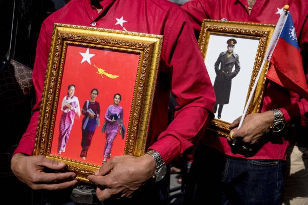 A protester holds a photo of Suu Kyi during a demonstration outside the Myanmar embassy in Bangkok