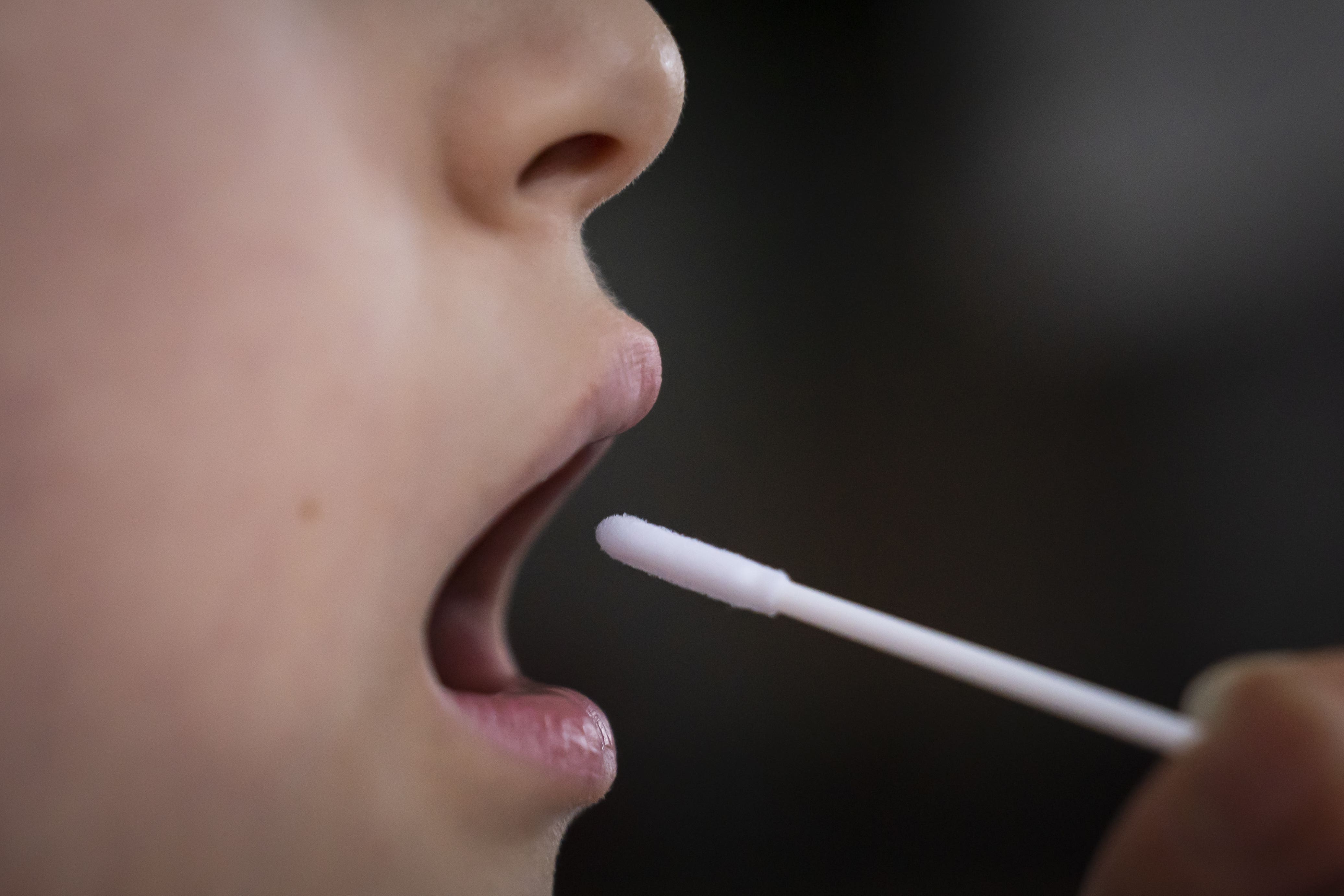 A person simulating taking a Covid 19 lateral flow test (Danny Lawson/PA)