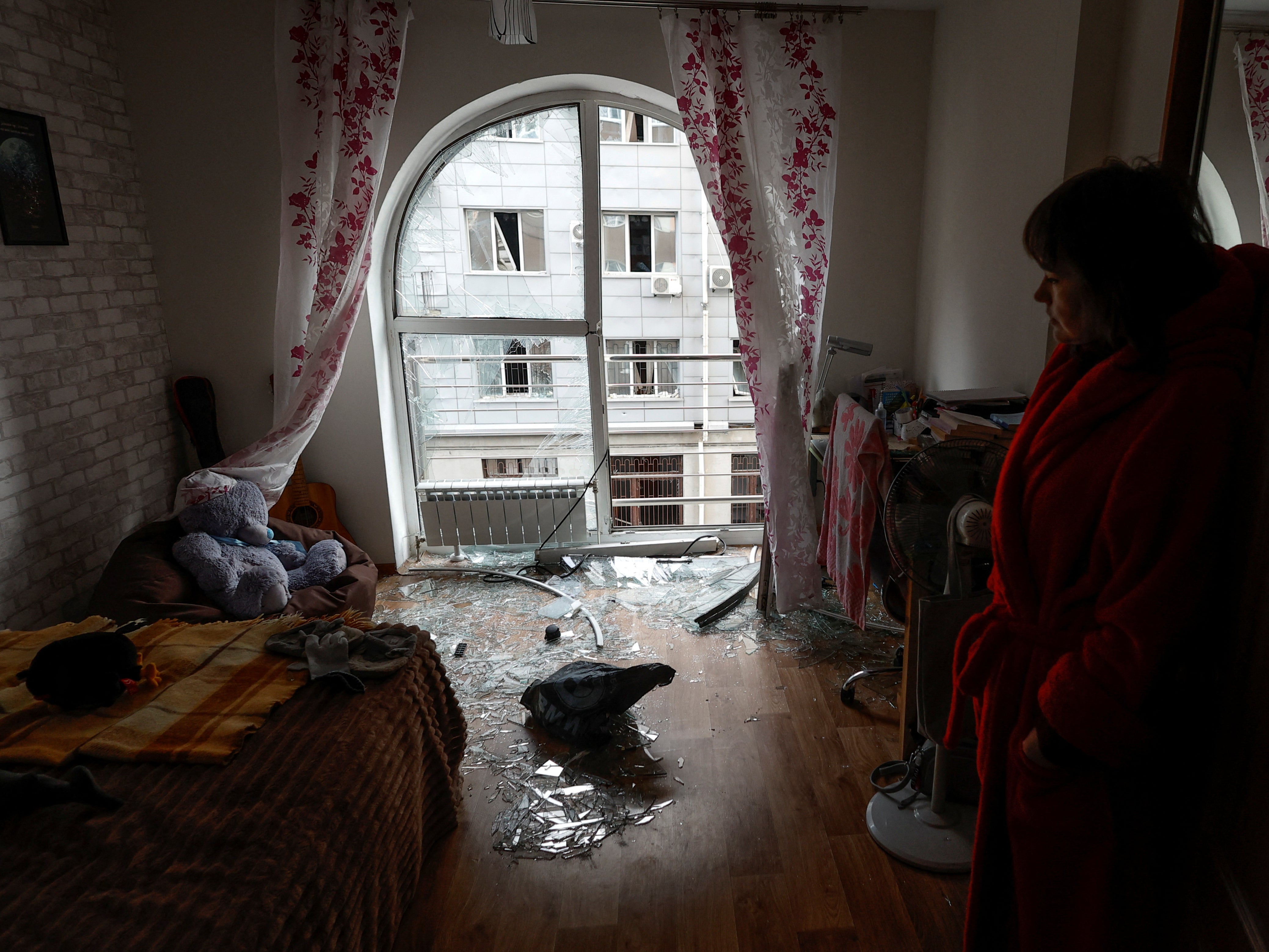 A resident looks at damage from a Russian drone strike