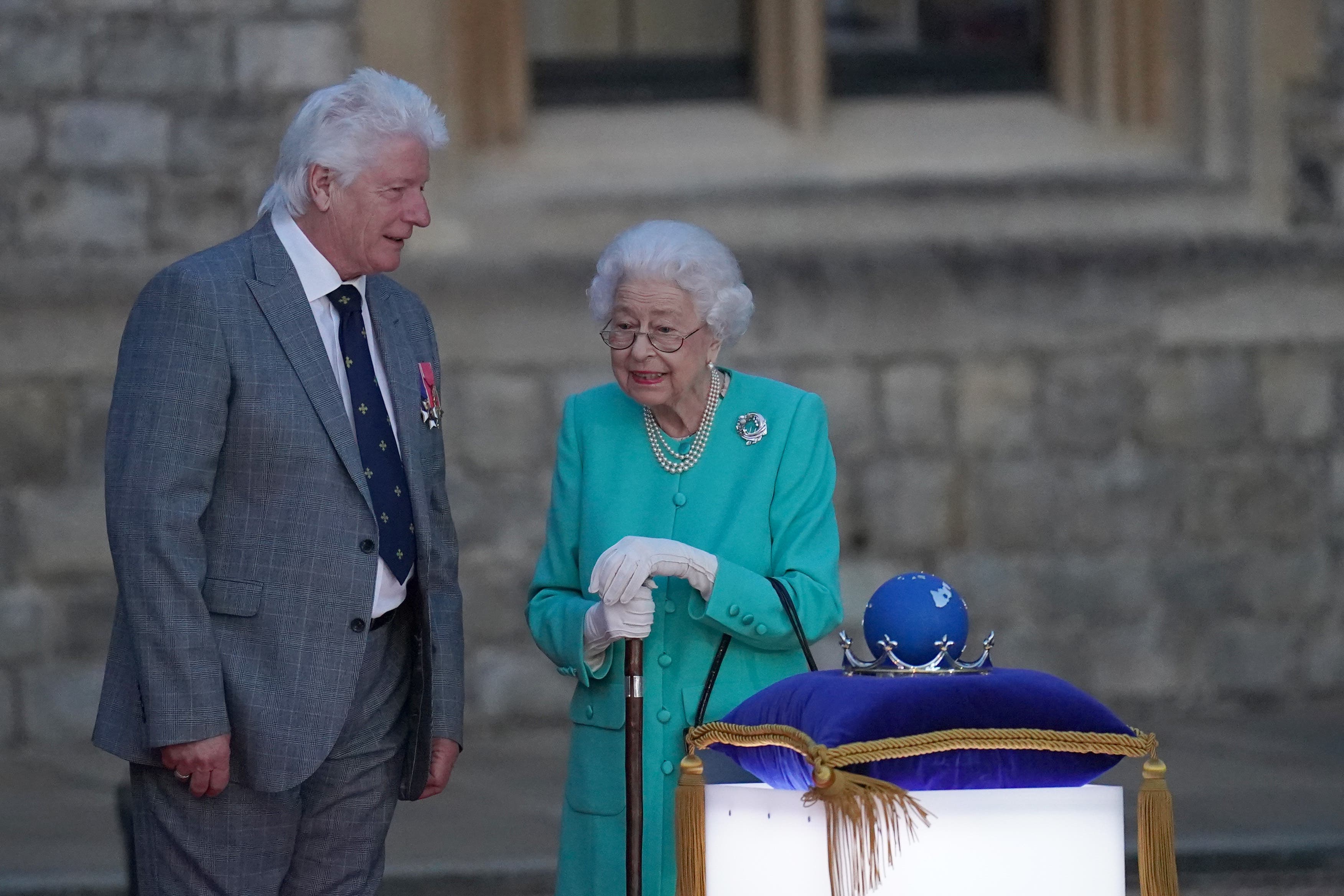 Queen Elizabeth II , with Bruno Peek, symbolically leads the lighting of the principal Jubilee beacon at Windsor Castle, as part of a chain of more than 3,500 flaming tributes to her 70-year-reign, on day one of the Platinum Jubilee celebrations. Over 3,000 towns, villages and cities throughout the UK, Channel Islands, Isle of Man and UK Overseas Territories, and each of the capital cities of Commonwealth countries are lighting beacons to mark the Jubilee. Picture date: Thursday June 2, 2022.