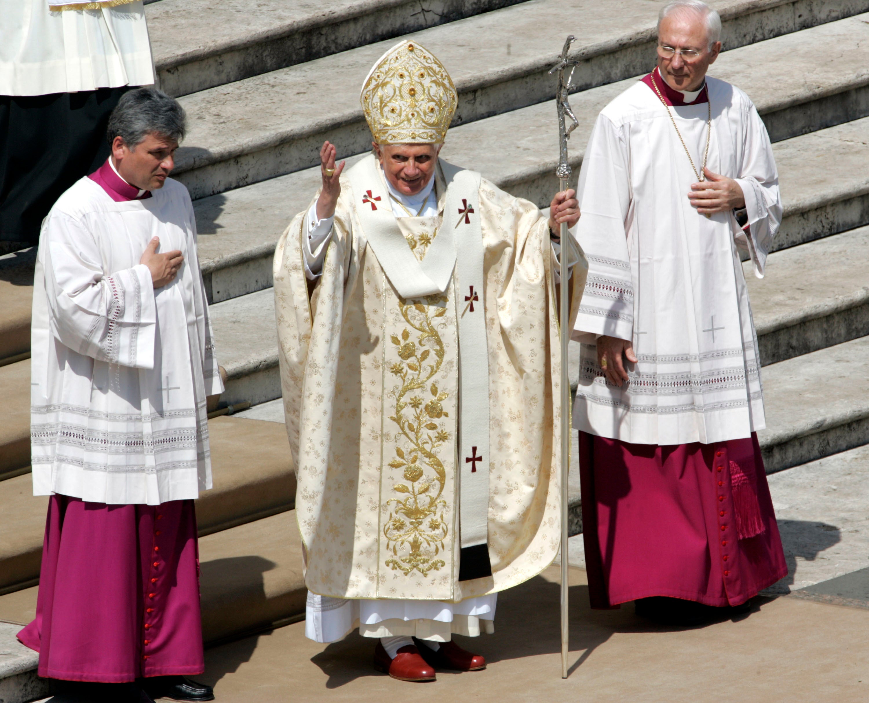 Pope Benedict XVI, center, flanked by Archbishop Piero Marini, master of ceremonies for liturgical celebrations, right, and an unidentified prelate, waves at the end of his 80th birthday Mass in St. Peter's Square at the Vatican in April 2007