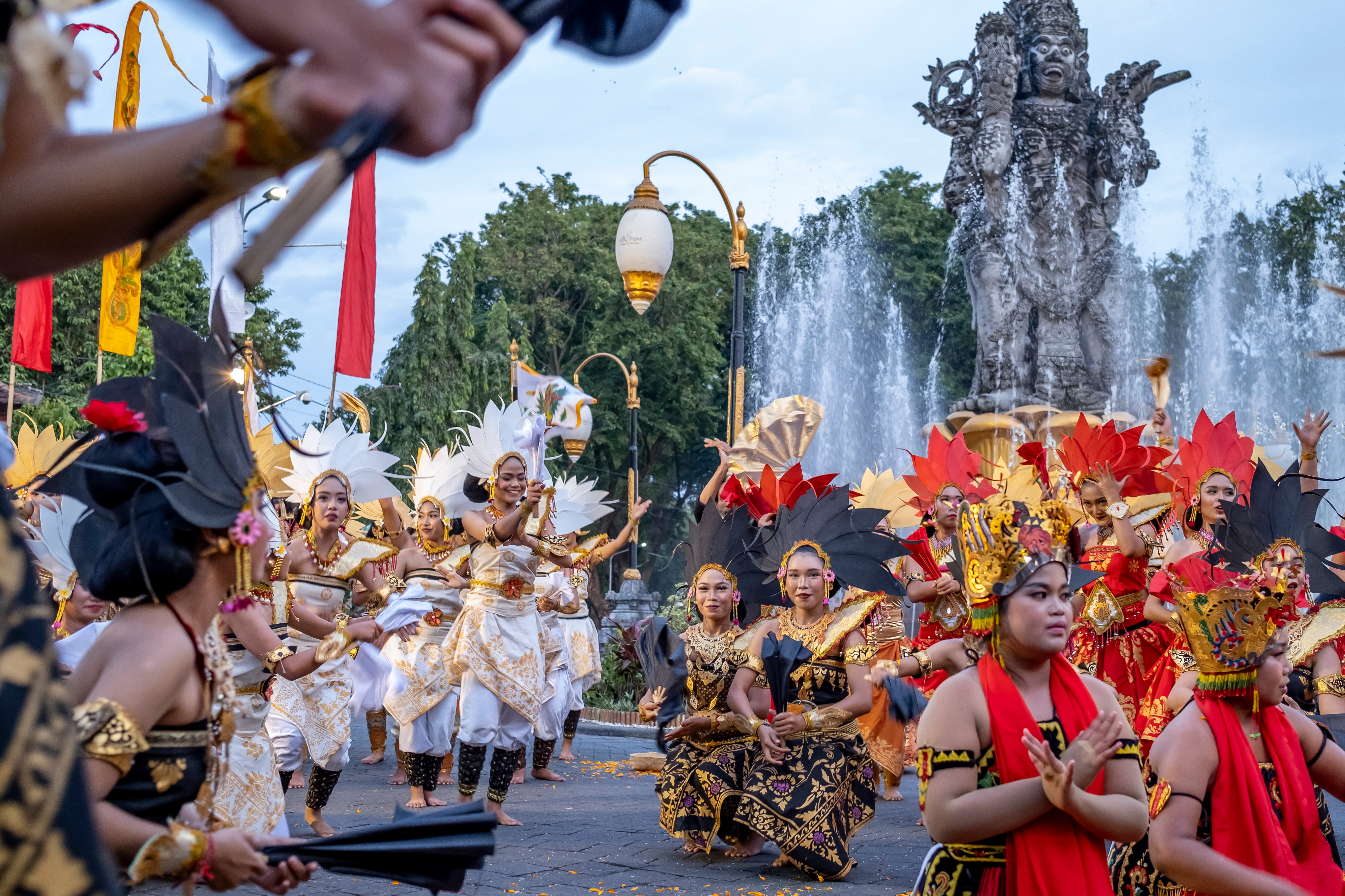 Balinese dancers perform as they take part in a cultural parade, during a new year's eve celebration at a main road in Denpasar