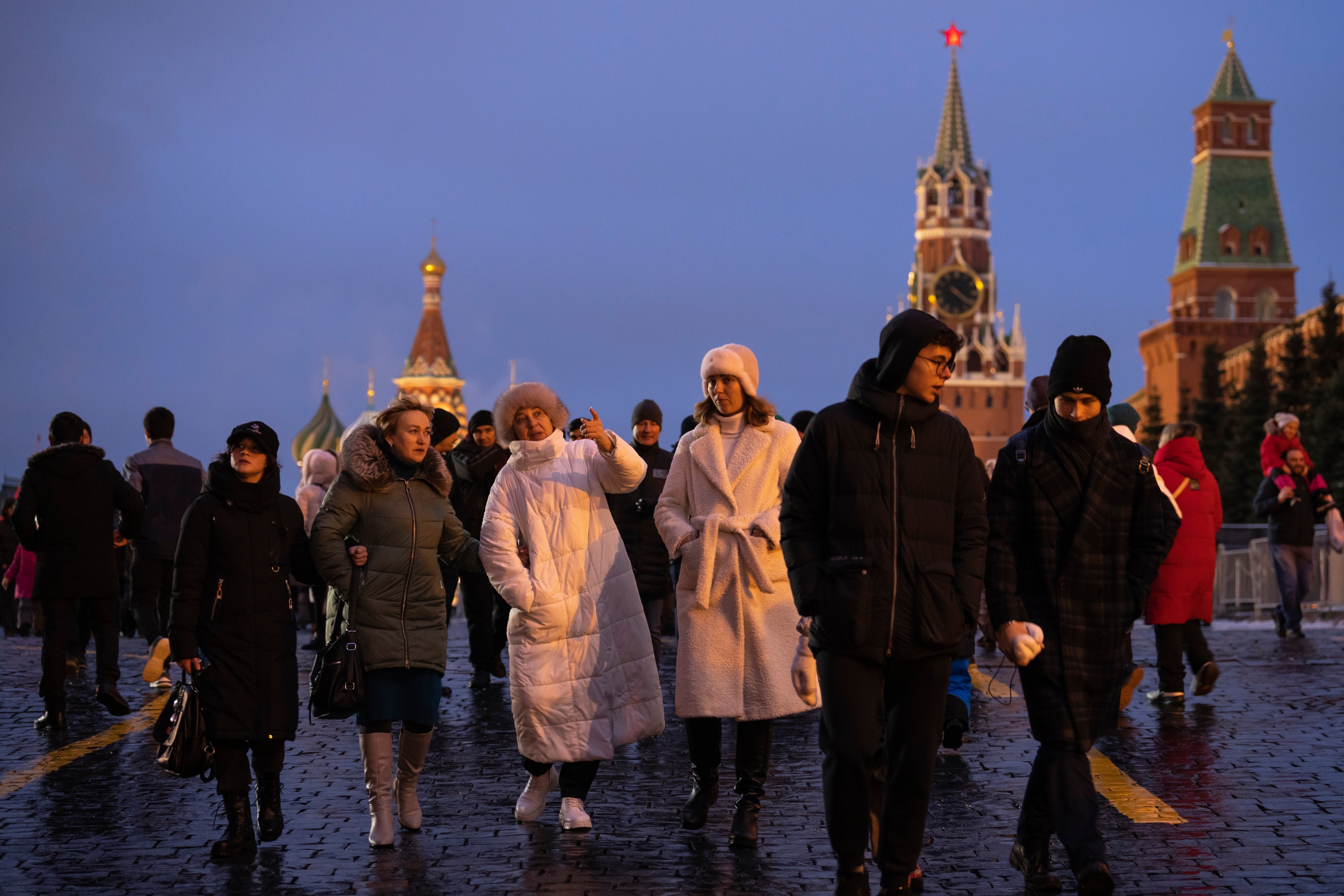 People walk in the Red Square prior to its closure for celebrations on the New Year's Eve