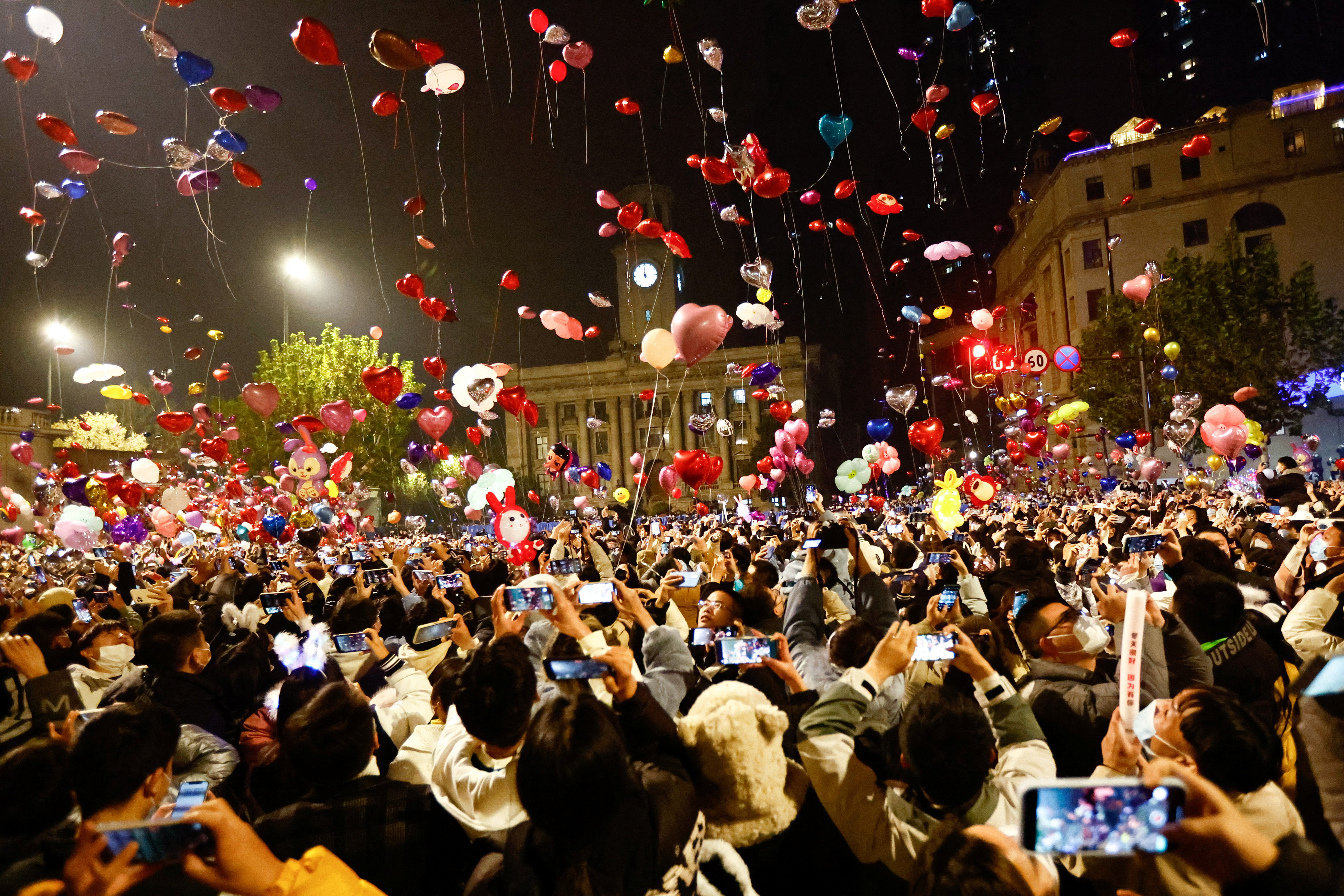 People release balloons as they gather to celebrate New Year's Eve in Wuhan, China