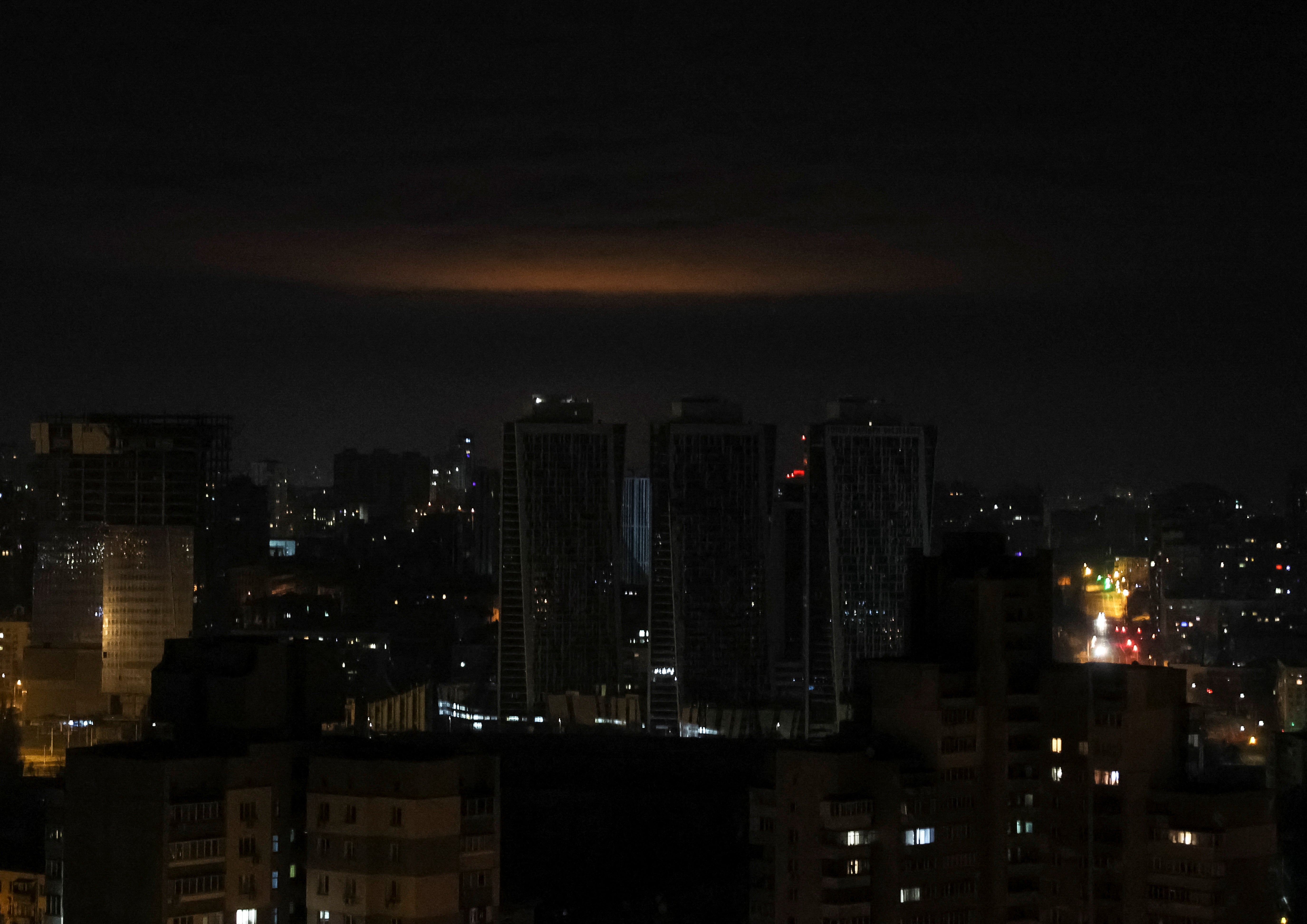 A glow from an explosion is seen over Kyiv’s skyline during a Russian drone strike on 1 January