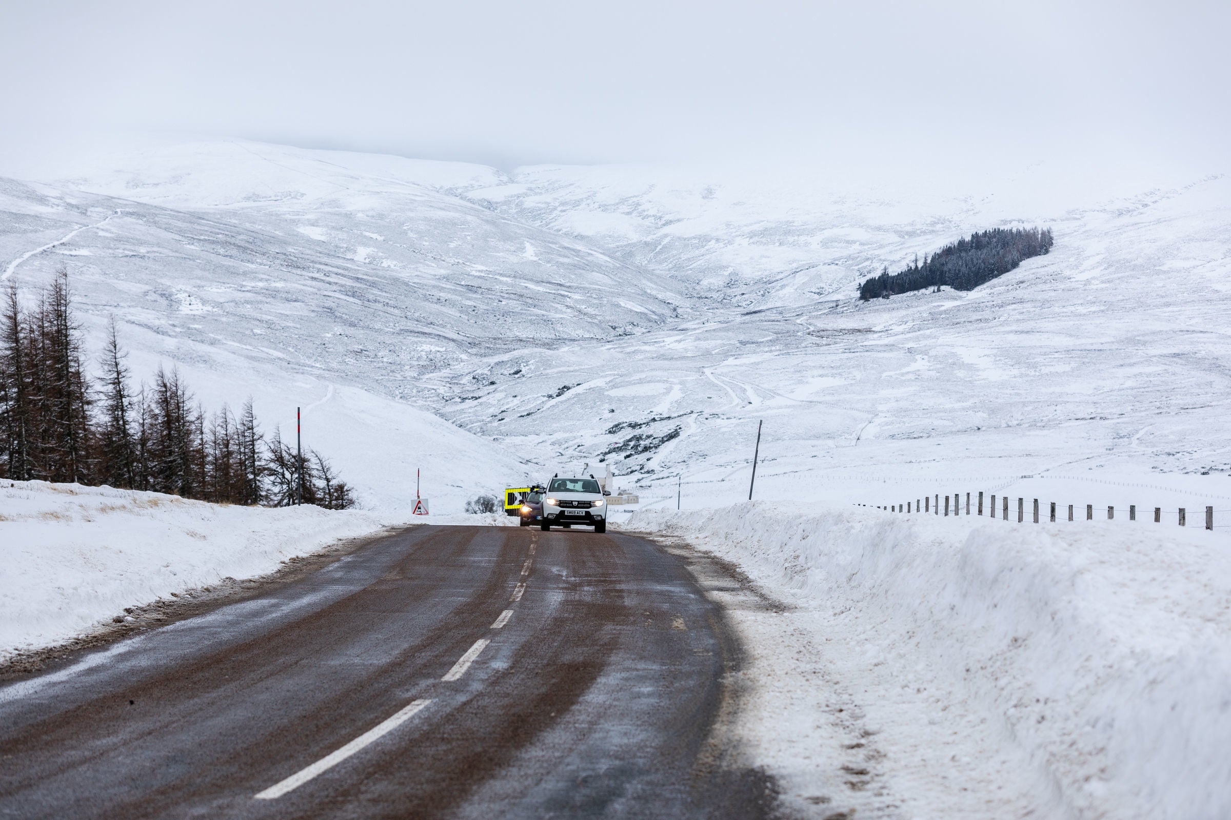 Cars make their way along the A939 after heavy snowfall in the Scottish Highlands