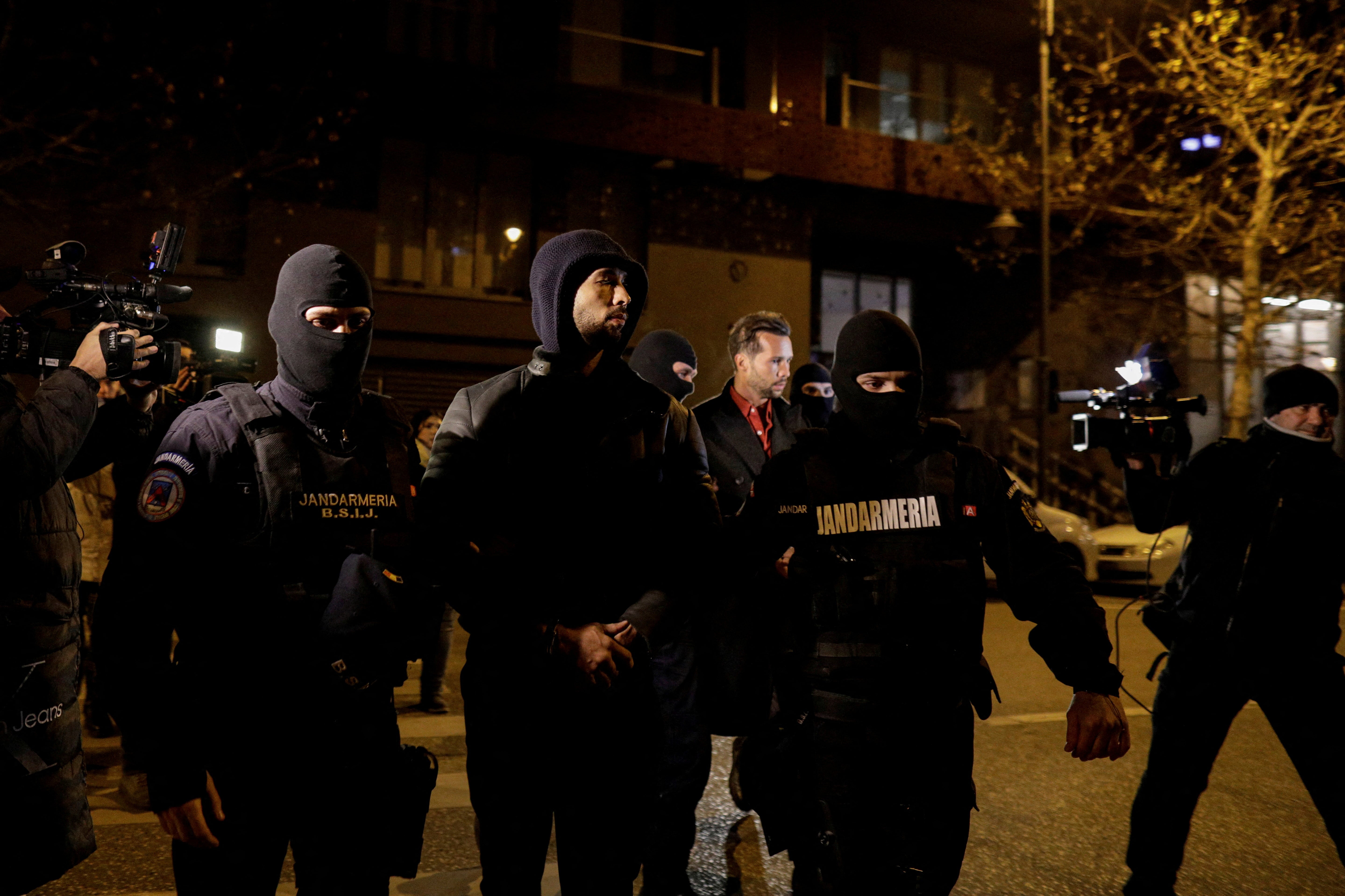 Andrew Tate was led away by Romanian police alongside his brother Tristan