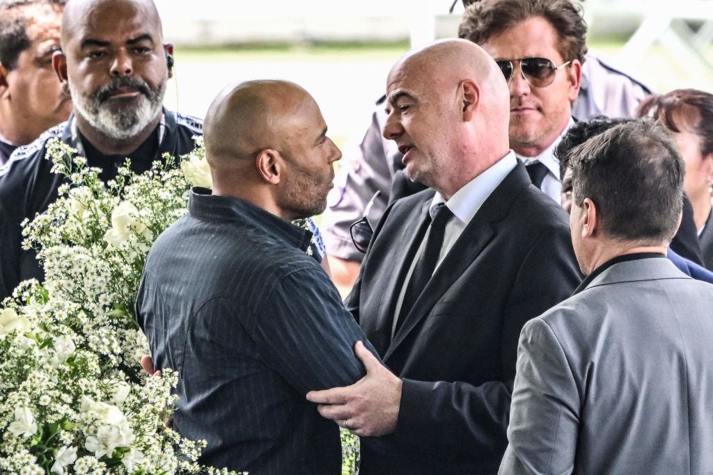 The Fifa president, Gianni Infantino, greets the son of Brazilian football legend Pele, Edinho