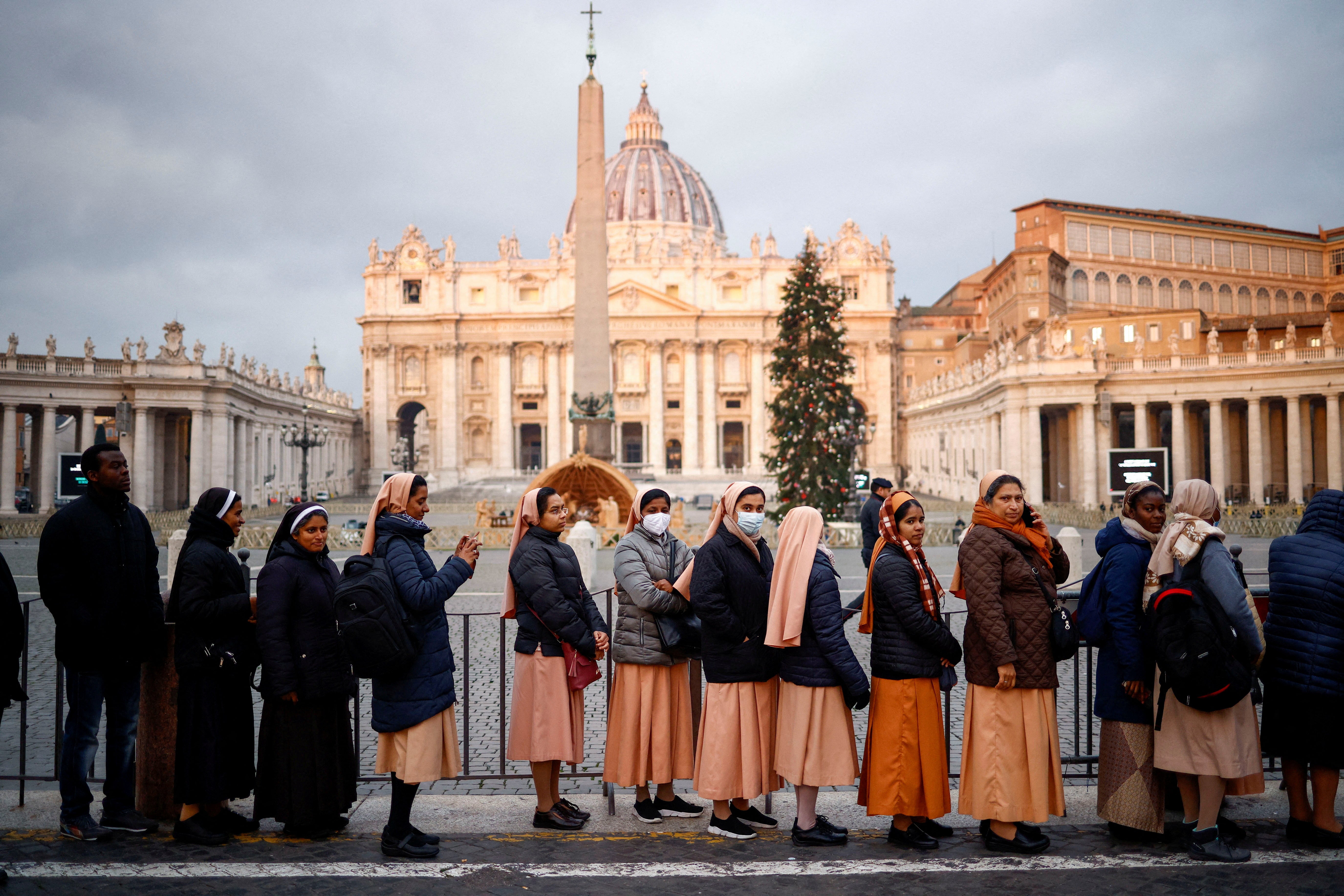 Mourners queue to enter St Peter’s Basilica to pay homage to the former Pope Benedict at the Vatican