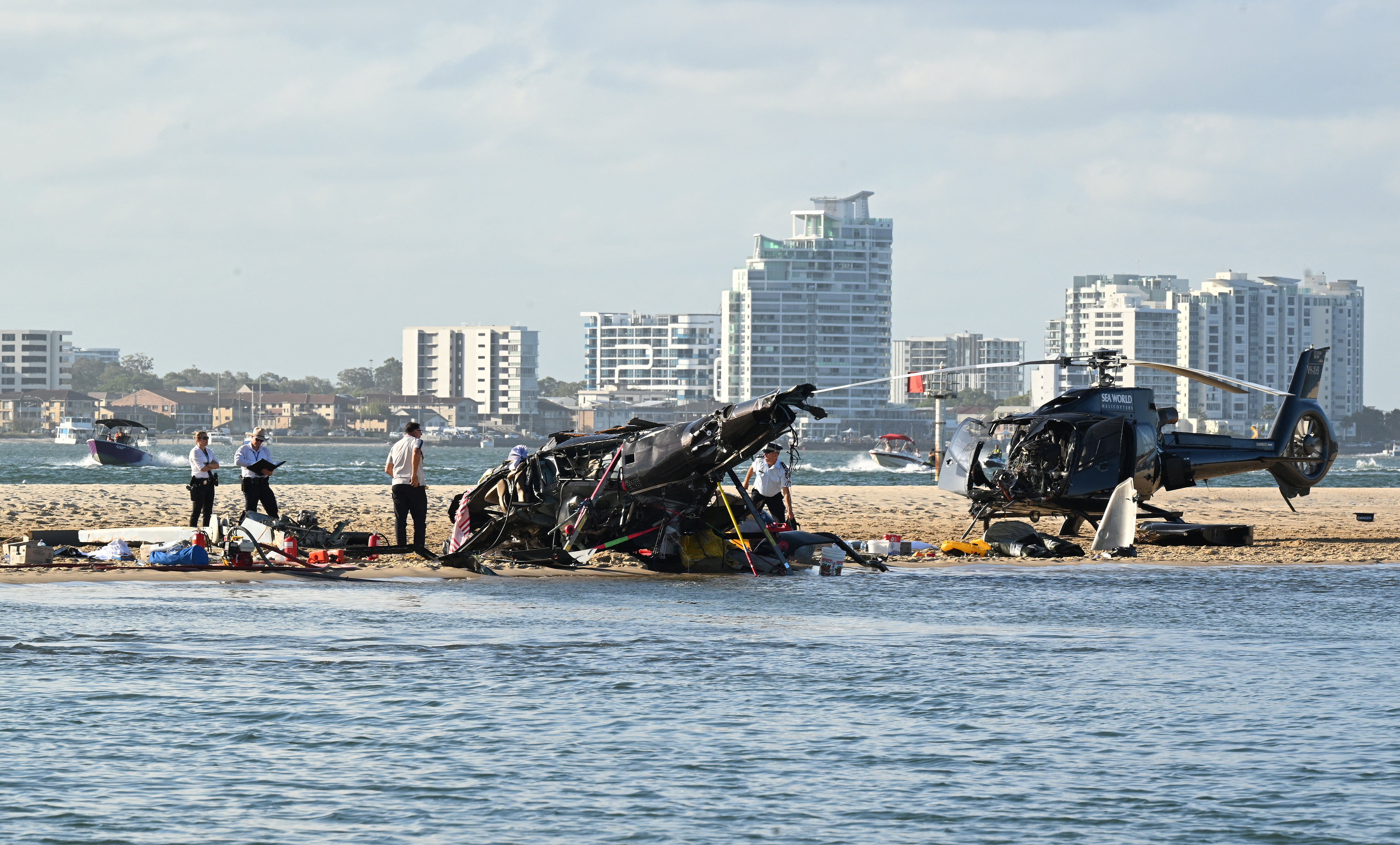 The wreckage of two helicopters are seen following a collision near Seaworld, on the Gold Coast