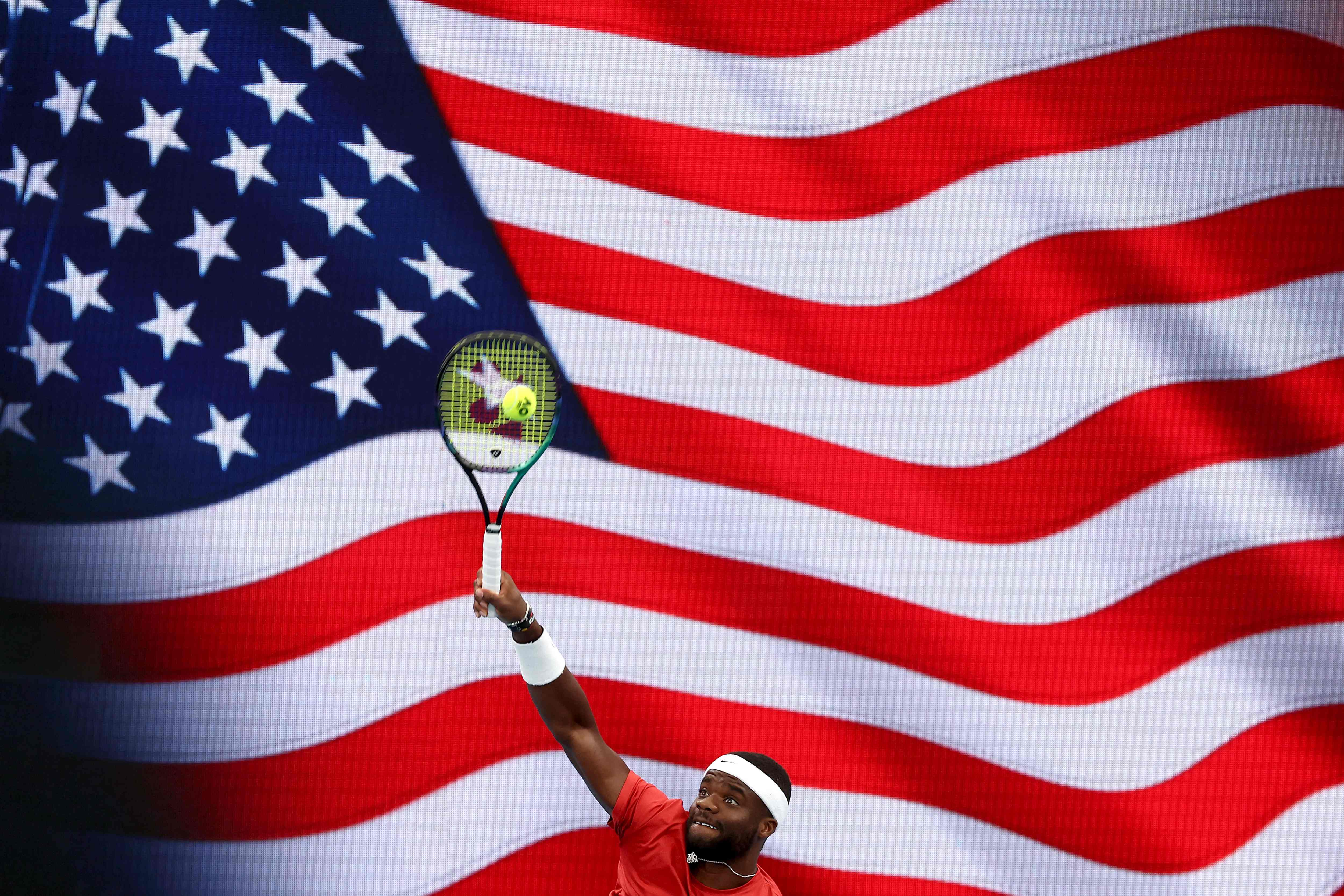 US’s Frances Tiafoe serves during a warm up session of the men’s singles match against Germany’s Oscar Otte on day six of the United Cup tennis tournament at Ken Rosewall Arena in Sydney