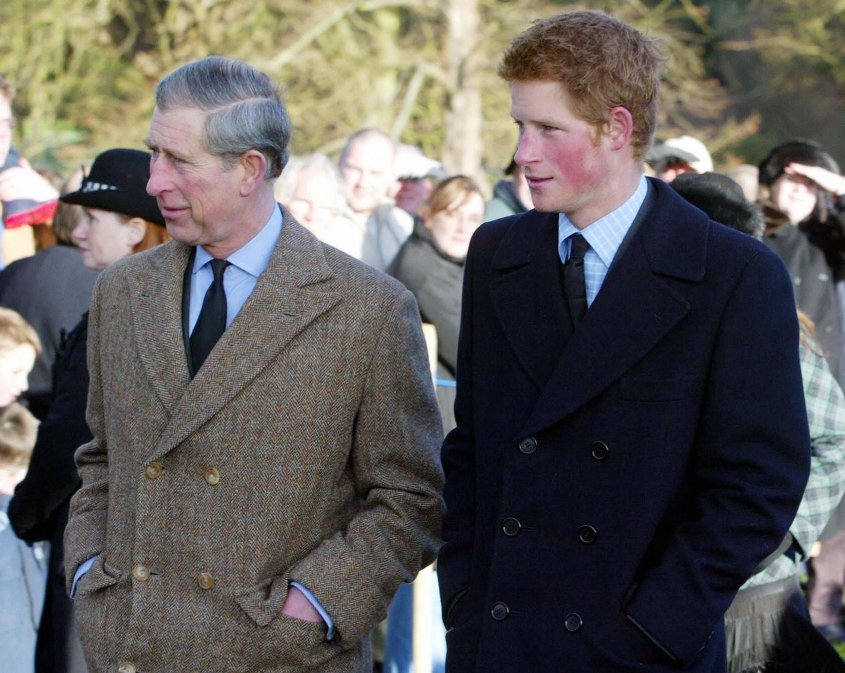 King Charles III with young Prince Harry at St Mary Magdalene Church on Sandringham estate, in 2004