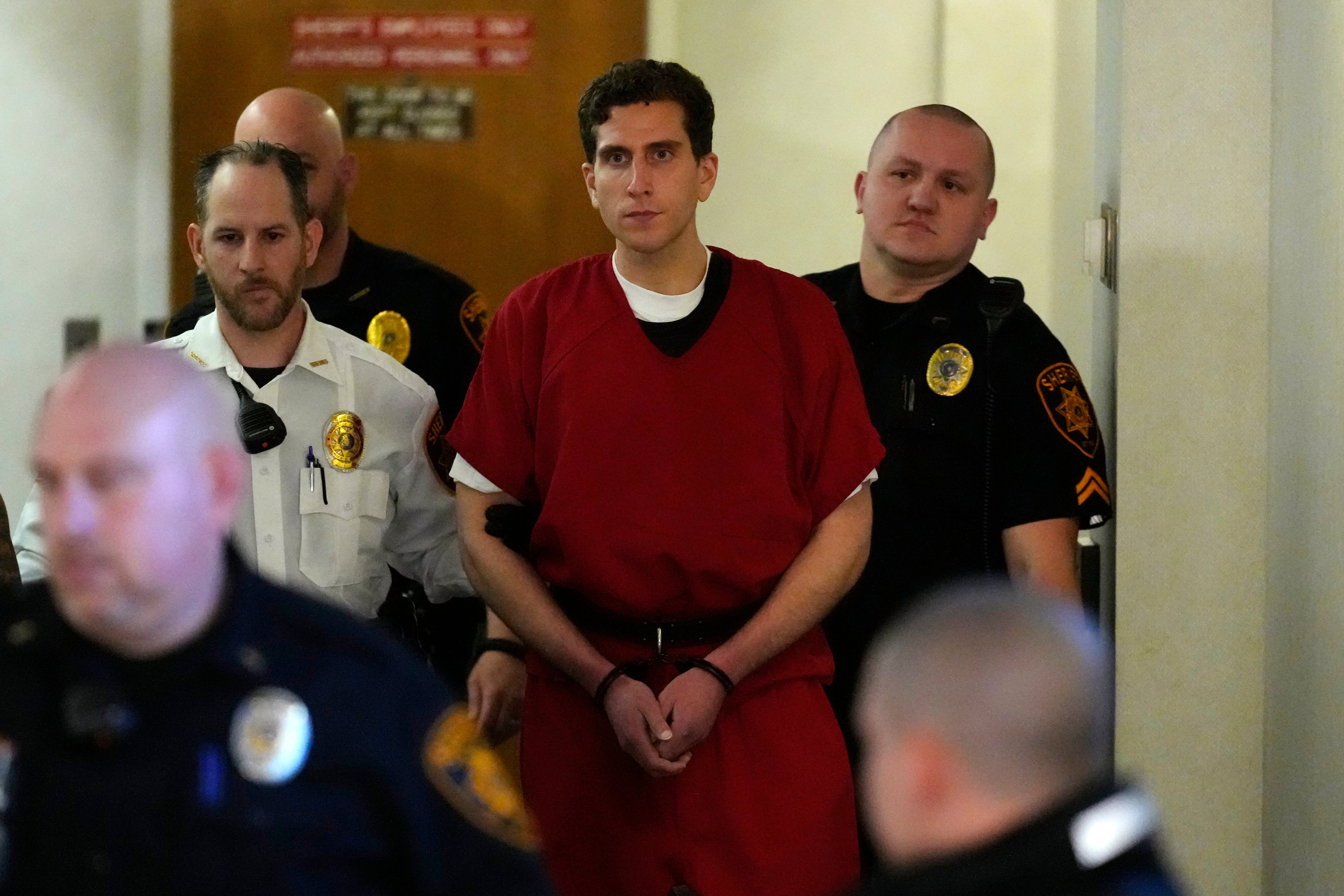 Bryan Kohberger is flanked by officers as he arrives at his extradition hearing on Tuesday