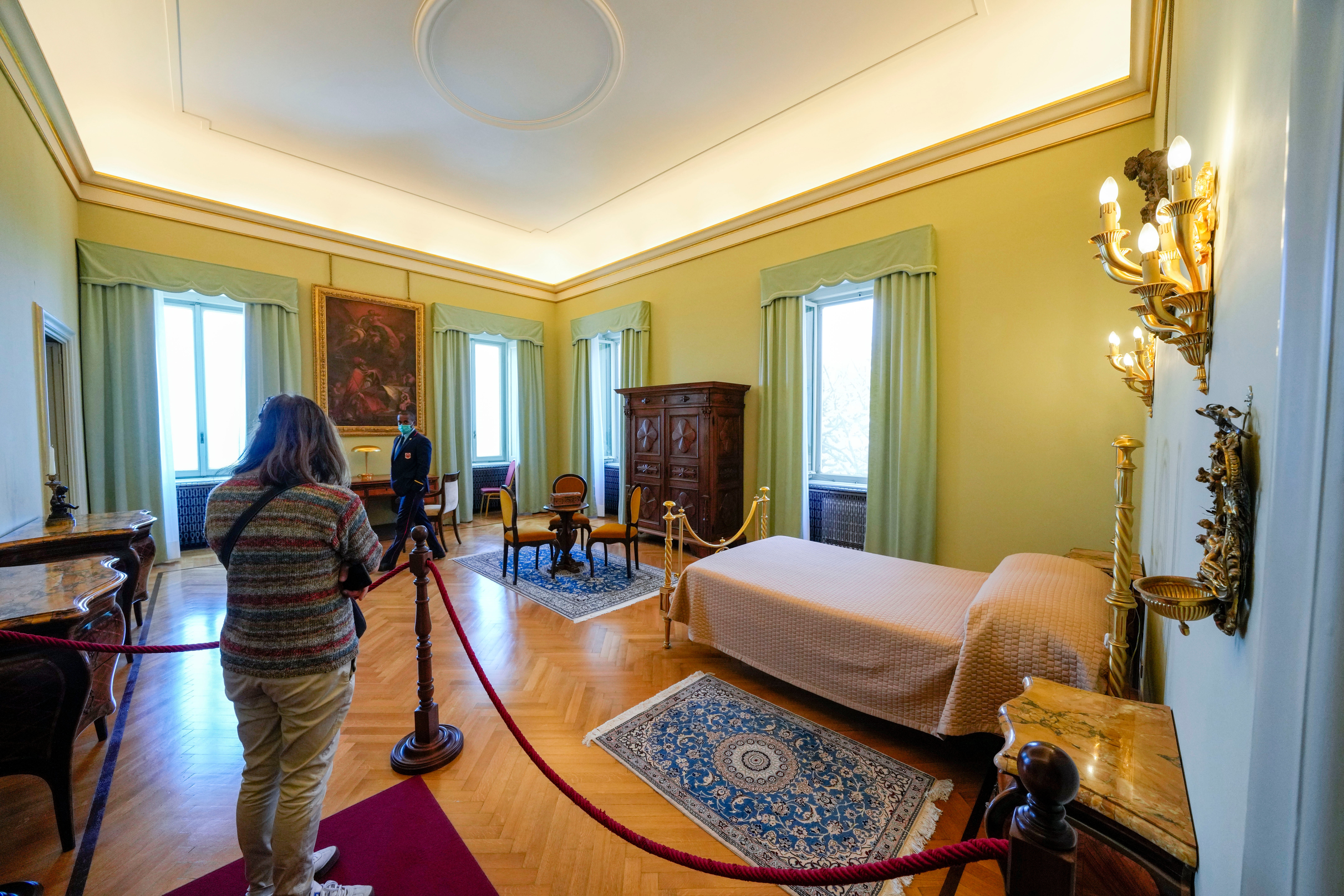 A visitor looks at the pope's bedroom inside the papal villa in Castel Gandolfo