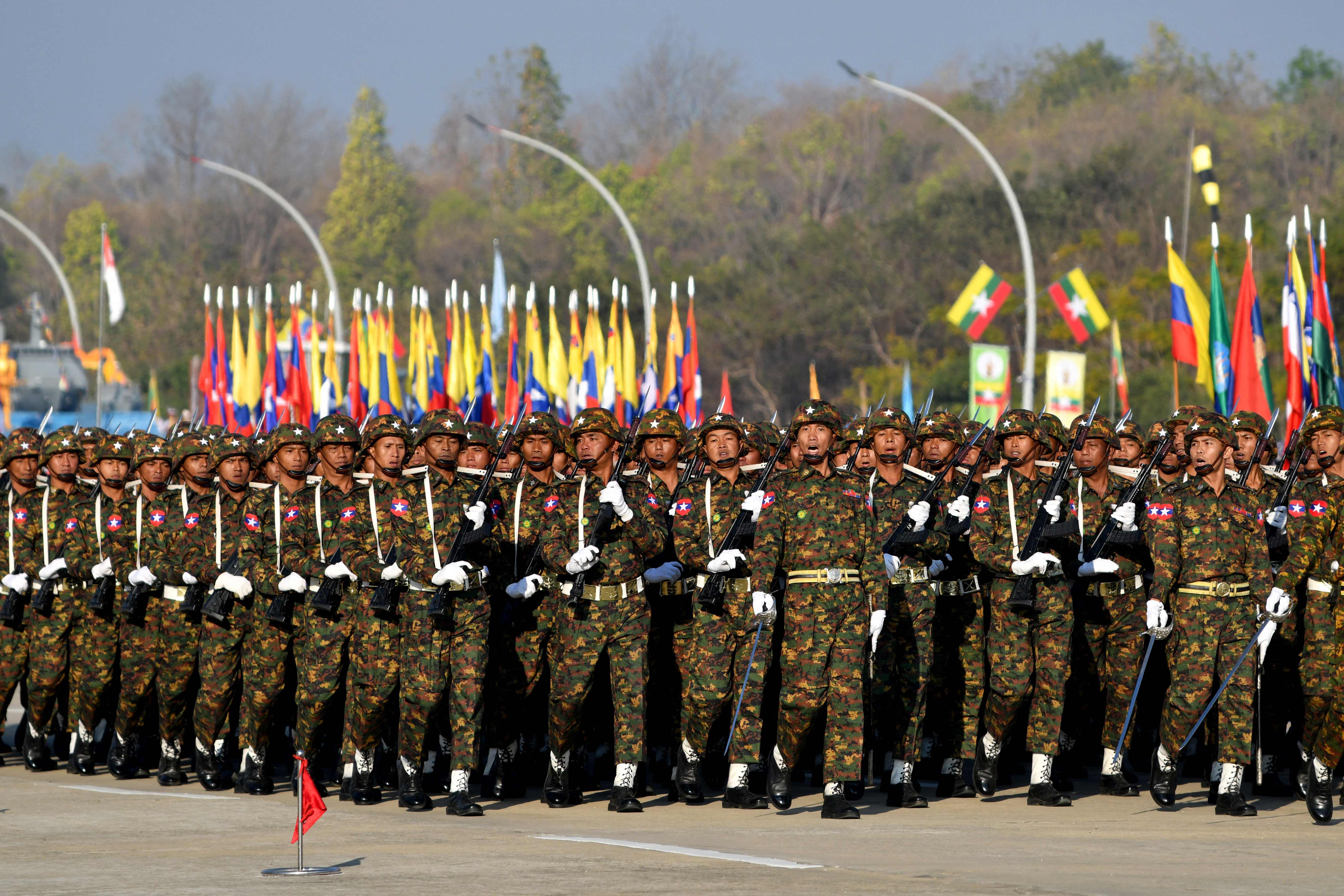 Members of the Myanmar military march at a parade ground to mark the country's Independence Day